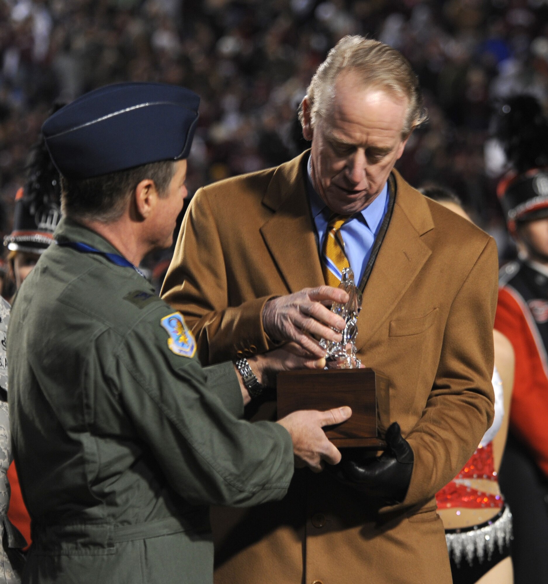 Barksdale AFB, La. – Col. Keith Schultz, 917th Operations Group pilot, hands the Omar N. Bradley “Spirit of Independence” Award to Archie Manning, who represented the National Football Foundation at the 2009 AdvoCare V100 Independence Bowl game Dec. 28. (U.S. Air Force photo by Senior Airman Alexandra Longfellow) (RELEASED)