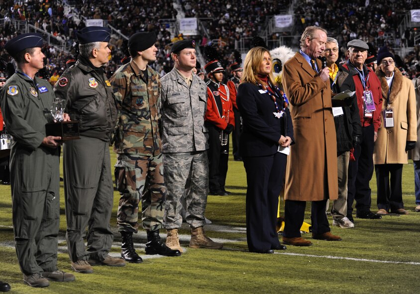 Barksdale AFB, La. – Air Force Reserve crew members of the B-52 flyover joined joint tactical air controllers from the Louisiana Air National Guard to present the prestigious Omar N. Bradley Award during halftime of the Independence Bowl Dec. 28. Col. Keith Shultz, 917th Operations Group pilot, presented the award to Archie Manning, who represented the National Football Foundation. (U.S. Air Force photo by Senior Airman Alexandra Longfellow) (RELEASED)