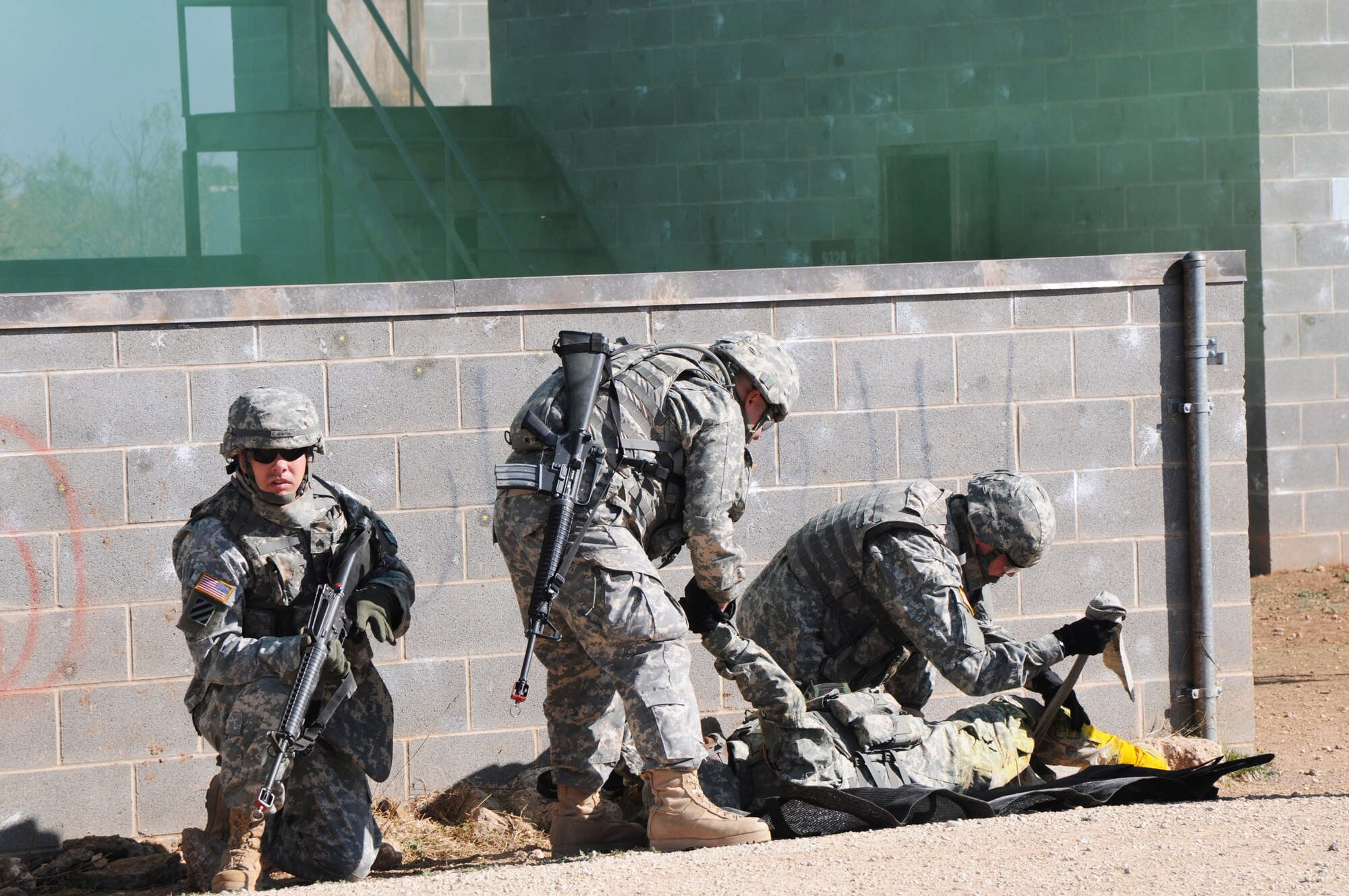 Soldiers from the 344th Military Intelligence Battalion, take part in a Military Operation in Urban Terrain demonstration at Forward Operating Base Sentinel during Community Appreciation day at Goodfellow Air Force Base, Texas, Nov. 21, 2009. The Army uses FOB Sentinel to hone their war fighting capabilities.  (U.S. Air Force Photo/Airman Clayton Lenhardt)