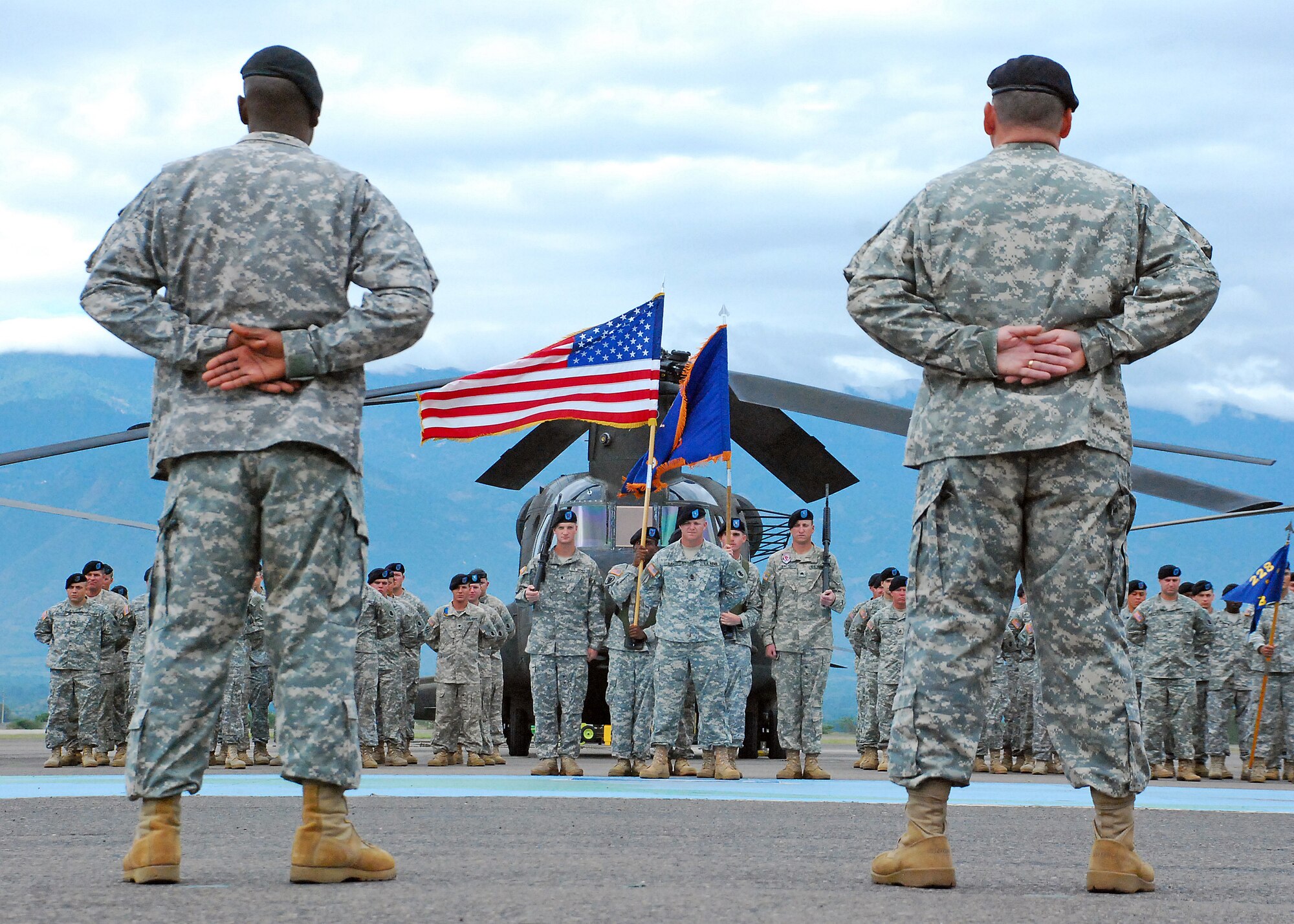 Command Sgt. Maj. Lucio DeAnda, 1st Battalion, 228th Aviation Regiment command sergeant major and outgoing 1/228th Command Sgt. Maj. Carlos Escalera stand at parade rest overlooking the 1/228th Soldiers during a change of responsibility ceremony Dec. 29 here. The 1/228th conducts general support aviation operations in support of Joint Task Force-Bravo. (Photo by U.S. Air Force Staff Sgt. Bryan Franks)