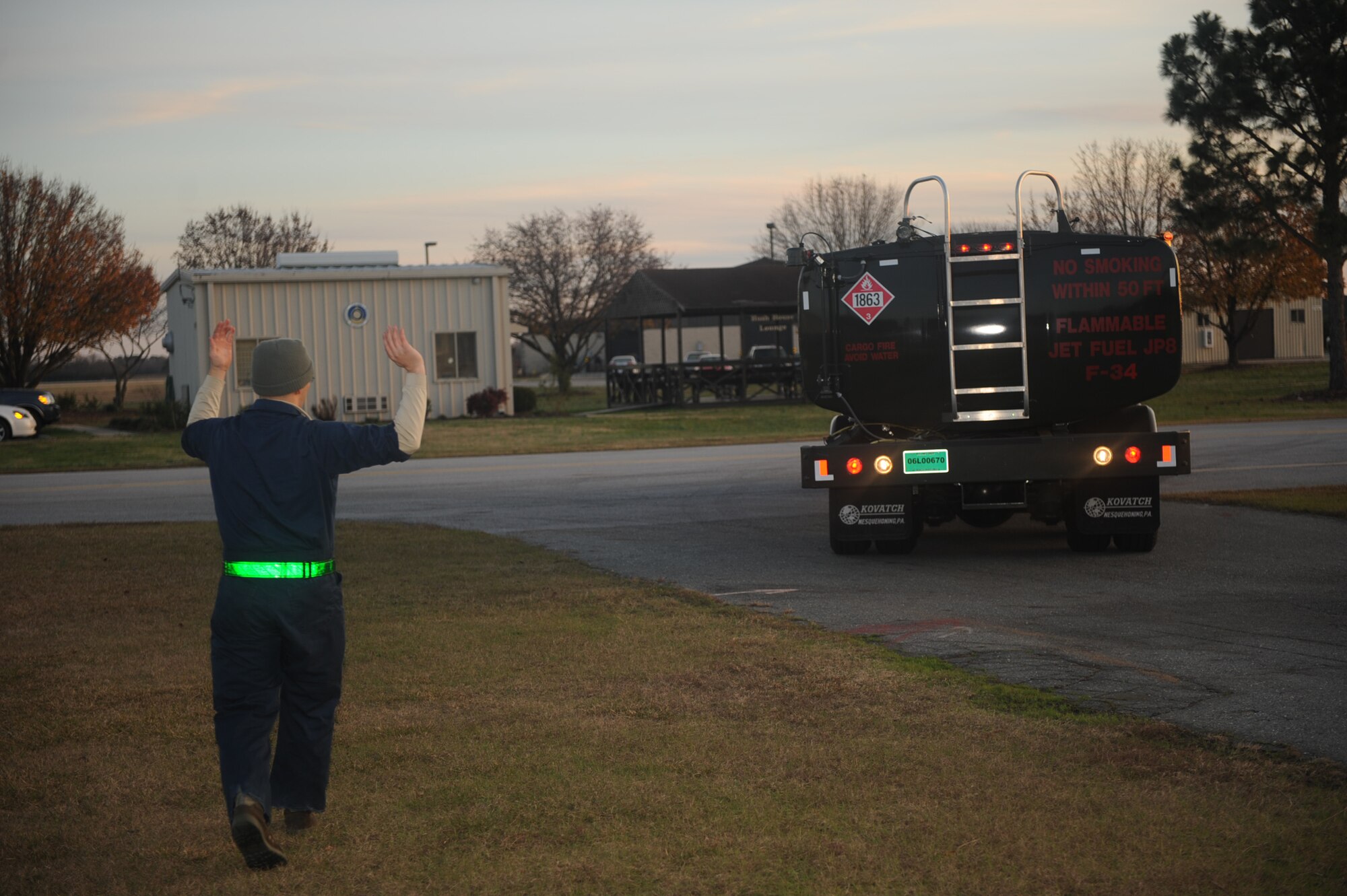 Senior Airman Isaiah Smith, 4th Component Maintenance Squadron aerospace propulsion technician marshals a truck for fuel tank servicing on Seymour Johnson Air Force Base, N.C., Dec. 17, 2009. Marshalling ensures the fuel truck backs into its parking spot without damaging anything outside of the driver's line of sight. (U.S. Air Force photo/Senior Airman Ciara Wymbs)