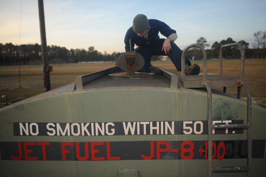 Senior Airman Isaiah Smith, 4th Component Maintenance Squadron aerospace propulsion technician, checks levels JP-8 engine fuel while servicing a fuel tank on Seymour Johnson Air Force Base, N.C., Dec. 18, 2009. Airman Smith monitors fuel levels to ensure there is an adequate amount of JP-8 during jet engine runs. Airman Smith hails from Rosalia, Kan. (U.S. Air Force photo/Senior Airman Ciara Wymbs)  