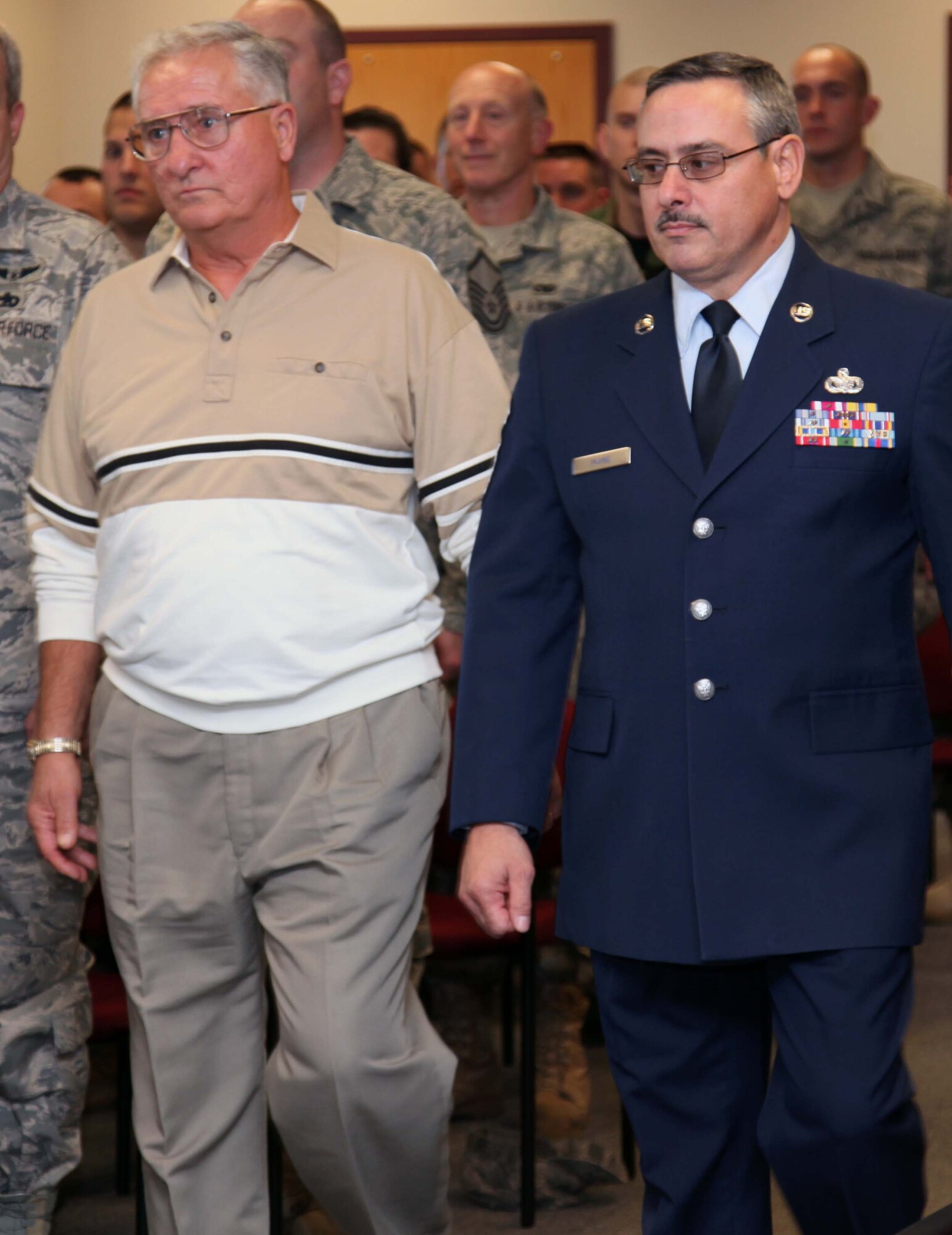 Retired Senior Master Sgt. Charles Mathias (left) stands beside Command Chief Master Sgt. John Payne (right) while being  inducted into the 911th Airlift Wing’s Hall of Fame during an informal ceremony Nov. 7.  Sergeant Mathias is the 21st member to be inducted. His last assignment was as first sergeant for the 32nd Aerial Port Squadron. The sergeant’s accomplishment’s included: providing his knowledge and experience in the air transportation career fields and as first sergeant during joint Army and Air Force training exercises Operations Pitt Provide II and Pitt Provide III, planning the 1995 Dining Out and creating the 911th Airlift Wing POW/MIA Honor Team. (Photo  by Airman Melissa Knox)
