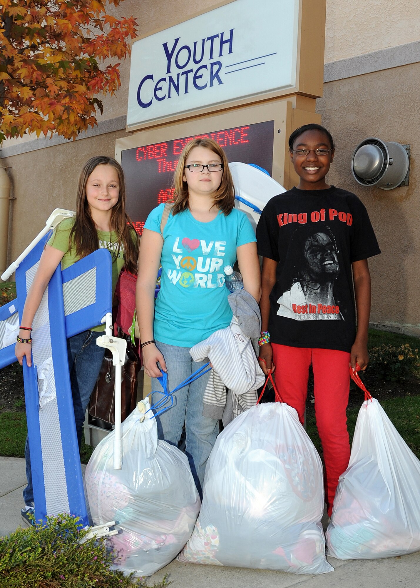 (left to right) Kattie Wesseling, Ashlee Reed and Maria Simmons are ready with bags of toys, clothing and other items to be delivered to the Union Rescue Mission, Los Angeles, to help those in need during this holiday season, Dec. 18.  The girls from the Los Angeles Air Force Base Youth Programs, along with YP leaders, delivered a van full of items collected through donations from the base’s Airman & Family Readiness Center, the Airmen’s Attic and several families on base. The event was part of YP’s Community Out Reach Program, which teaches youths the importance of humanity and caring for others. (Photo by Joe Juarez)