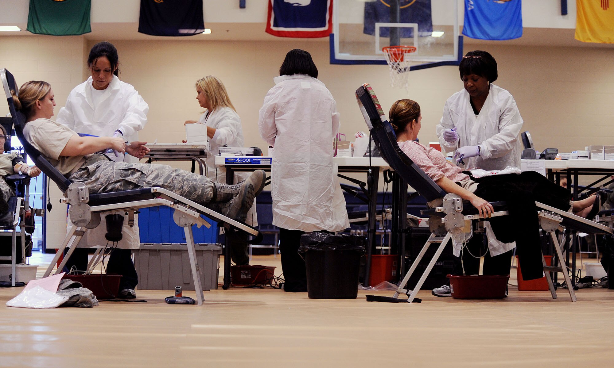 MOODY AIR FORCE BASE, Ga. -- Tech. Sgt. Danielle Hemberger, 23rd Force Support Squadron manpower analyst, and Katie Cockerill, 23rd Contracting Squadron contract specialist, donate blood during  the American Red Cross blood drive here Dec. 22. On average, the state of Georgia has to import 50,000 units of blood from other states each year to meet its needs. (U.S. Air Force photo by Airman 1st Class Joshua Green)