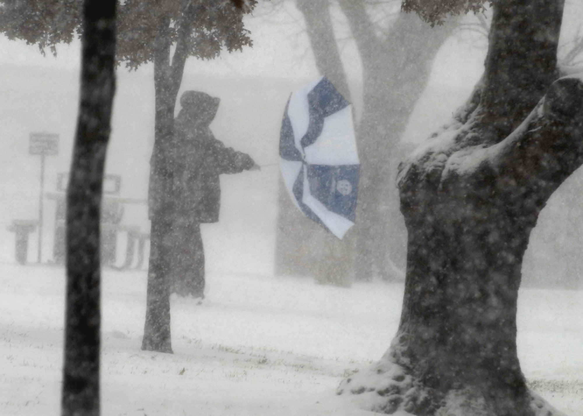 Strong winds cause an umbrella to go "inverted" Dec. 24 during a snow storm at Sheppard Air Force Base, Texas. The North Texas region received 10-15 inches of snow and ice in one day. (U.S. Air Force photo/Harry Tonemah)