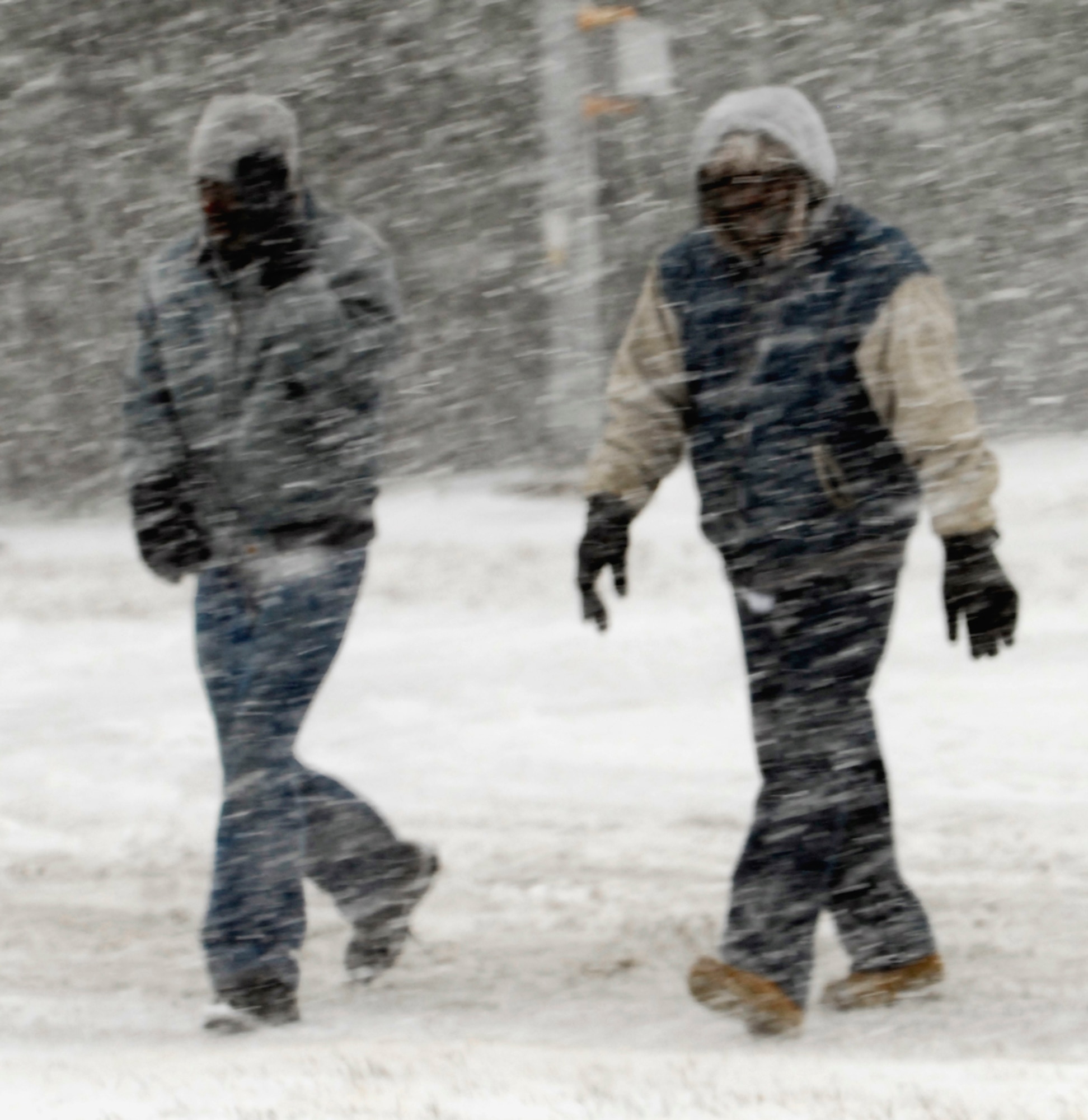 Two people brave the wintry conditions Dec. 24 on Sheppard Air Force Base, Texas. Some places in the North Texas region received 10-15 inches of snow and ice, causing hazardous driving conditions. (U.S. Air Force photo/Harry Tonemah)