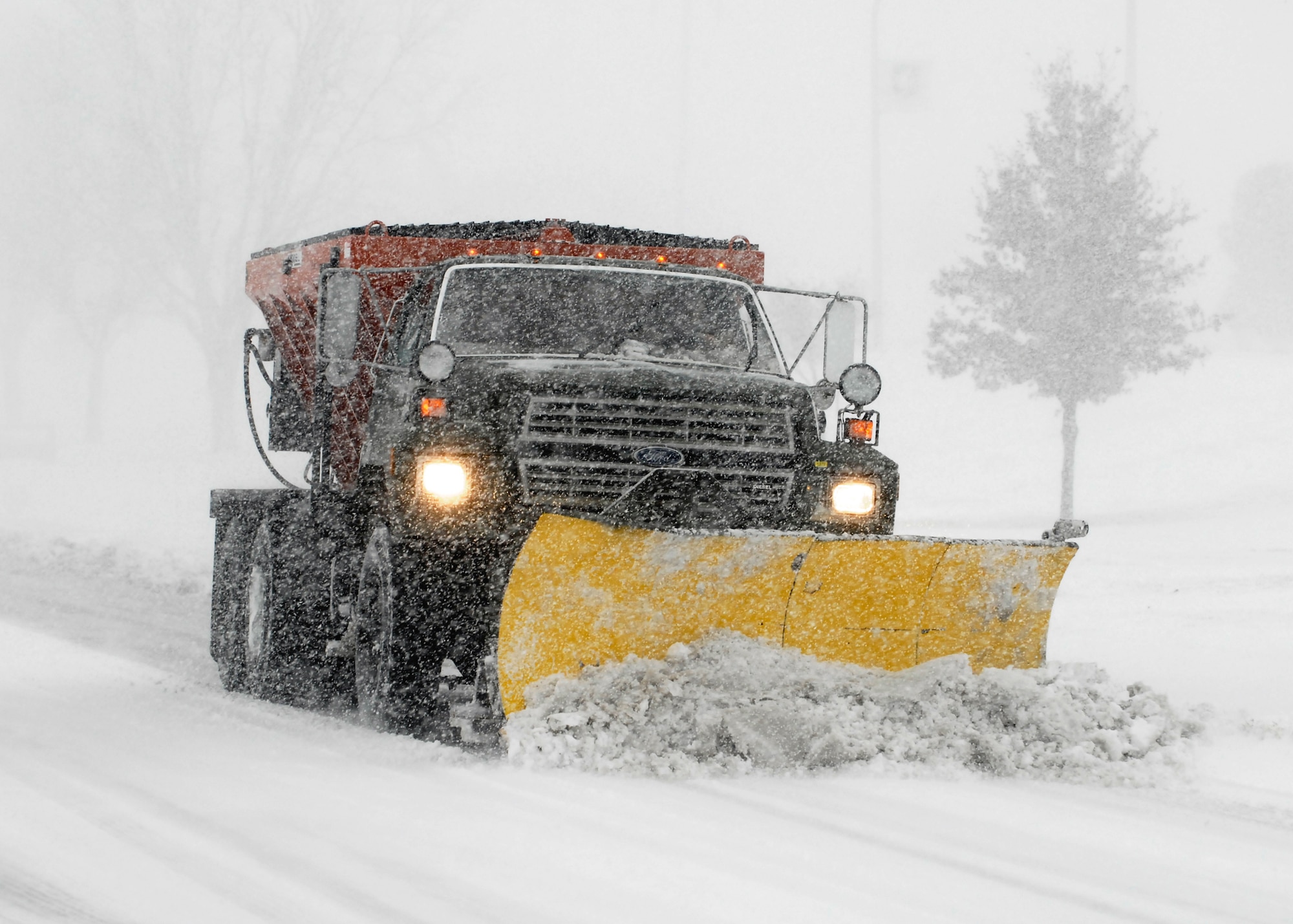 A truck with a snow blade clears a road on Sheppard Air Force Base, Texas, Dec. 24 after a blizzard blew through North Texas. Some places in the region received 10-15 inches of snow and ice. (U.S. Air Force photo/Harry Tonemah)