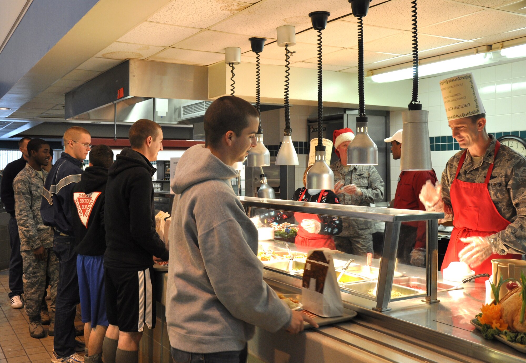 Col. Kevin Schneider, 80th Flying Training Wing commander serves Christmas meals to Airmen Dec. 25. Officers manned the food stations at the Tumbleweed Dining Facility during this year’s event. (U.S. Air Force Photo/ Airman 1st Class Adawn Kelsey)