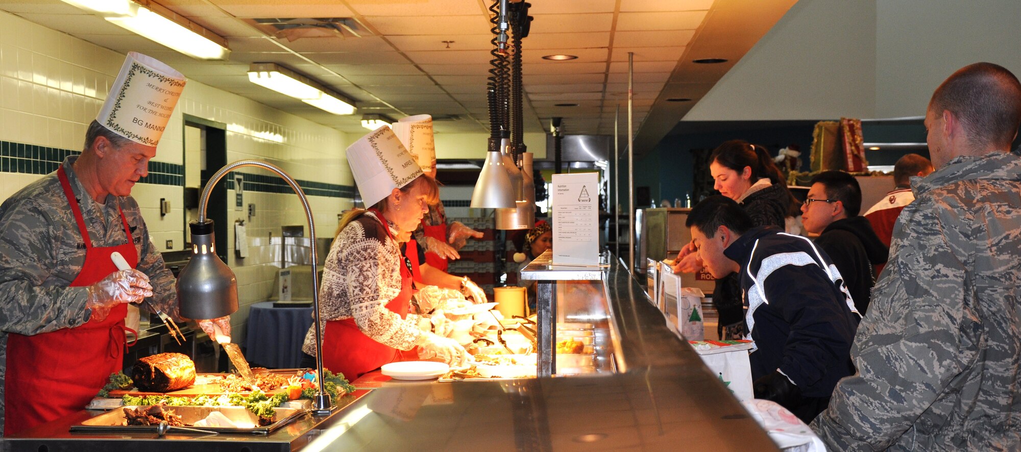 Brig. Gen. O.G. Mannon, 82nd Training Wing commander, serves Christmas meals to Airmen Dec. 25. Officers manned the food stations at the Tumbleweed Dining Facility during this year’s event. (U.S. Air Force Photo/ Airman 1st Class Adawn Kelsey)