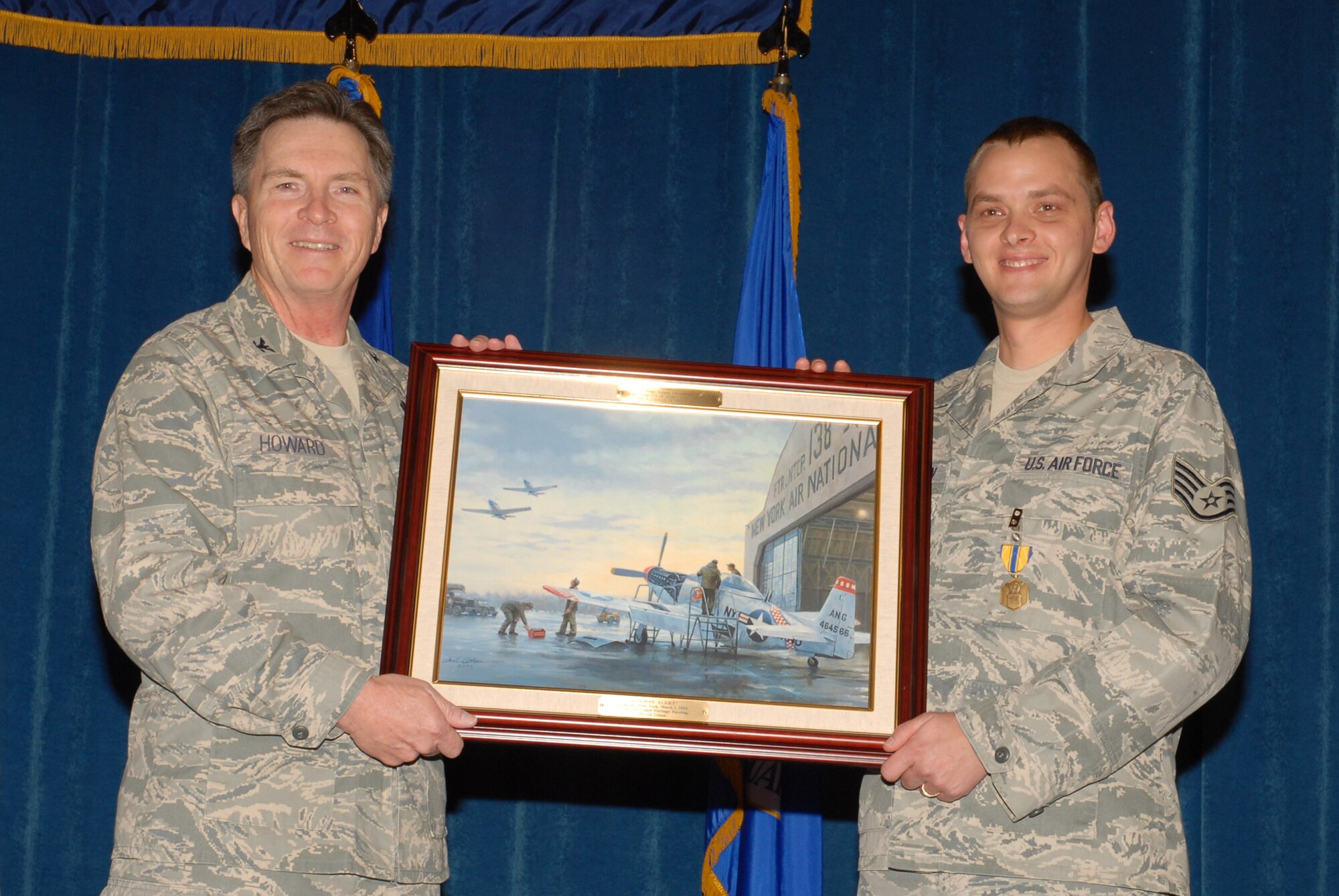 McGHEE TYSON AIR NATIONAL GUARD BASE, Tenn. -- Staff Sgt. Adam B. Thornton, right, an enlisted professional military education instructor, receives a heritage painting from Col. Richard B. Howard, commander, upon his departure from assignment at The I.G. Brown Air National Guard Training and Education Center here, Dec. 18, 2009.  (U.S. Air Force photograph by Master Sgt. Mavi Smith/Released)