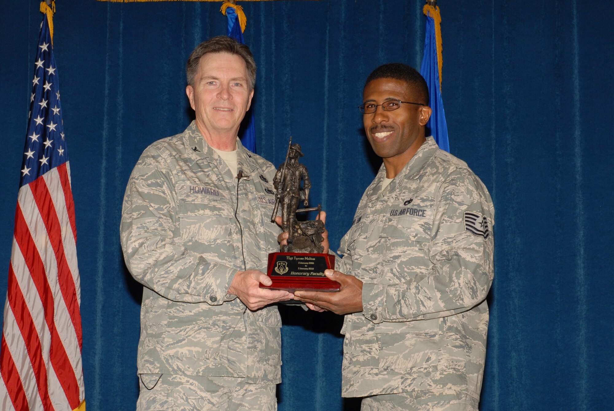 McGHEE TYSON AIR NATIONAL GUARD BASE, Tenn. -- Tech. Sgt. Tyrone E. Melton, right, an enlisted professional military education instructor, receives the honorary faculty award from Col. Richard B. Howard, commander, upon his departure from assignment at The I.G. Brown Air National Guard Training and Education Center here, Dec. 18, 2009.  (U.S. Air Force photograph by Master Sgt. Mavi Smith/Released)