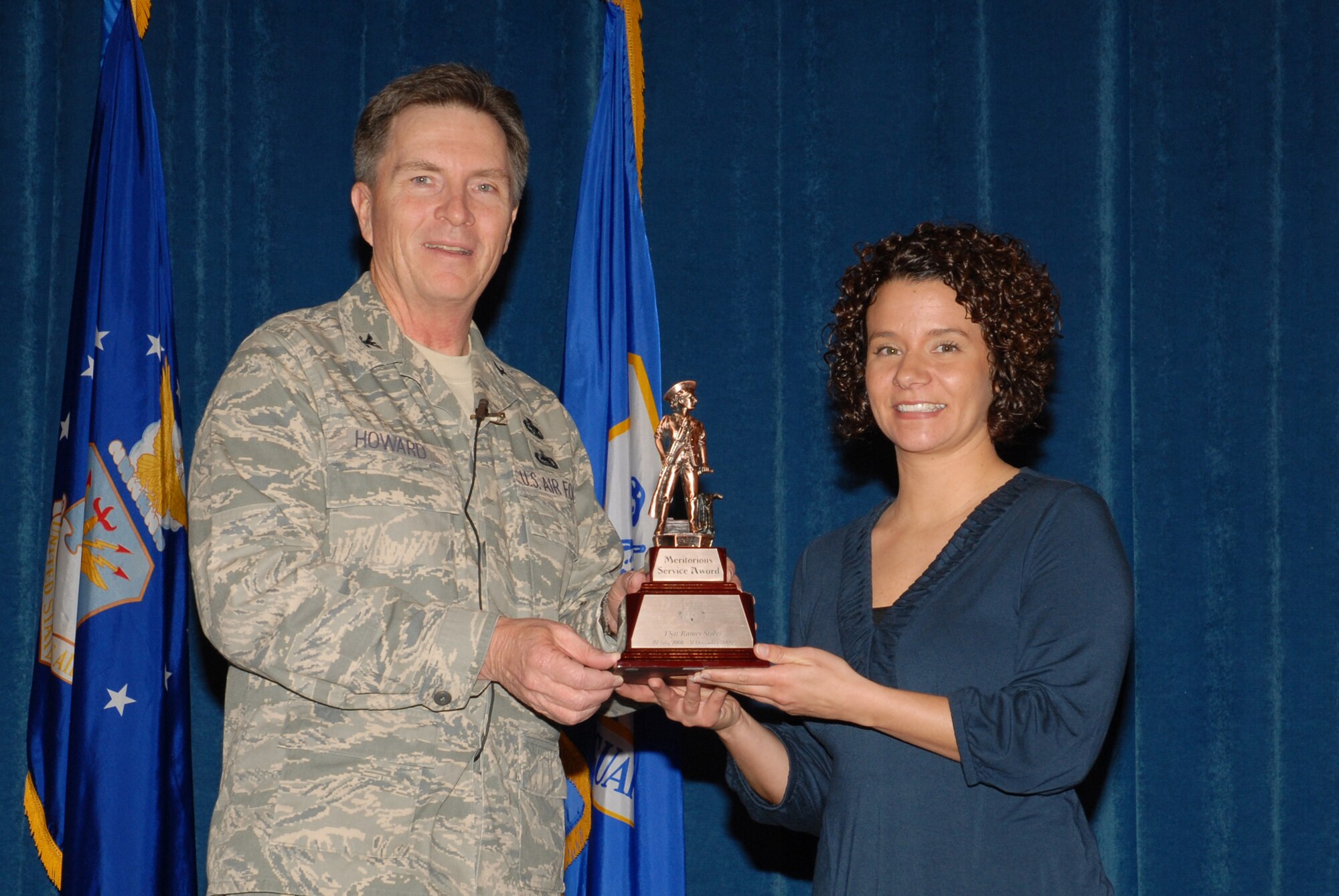 McGHEE TYSON AIR NATIONAL GUARD BASE, Tenn. -- Tech. Sgt. A. Ramey Stokes, right, an enlisted professional military education instructor, receives the meritorious service award from Col. Richard B. Howard, commander, upon her departure from assignment at The I.G. Brown Air National Guard Training and Education Center here, Dec. 18, 2009.  (U.S. Air Force photograph by Master Sgt. Mavi Smith/Released)