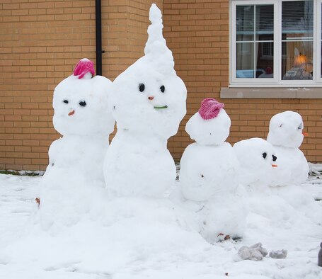Base housing residents took advantage of being at home after a night of heavy snow and ice by making snowmen at RAF Lakenheath, England, Dec. 22. The Liberty Wing had to shut down for the day due to the winter weather and road conditions.  (U.S. Air Force photo by Tim Barlow)