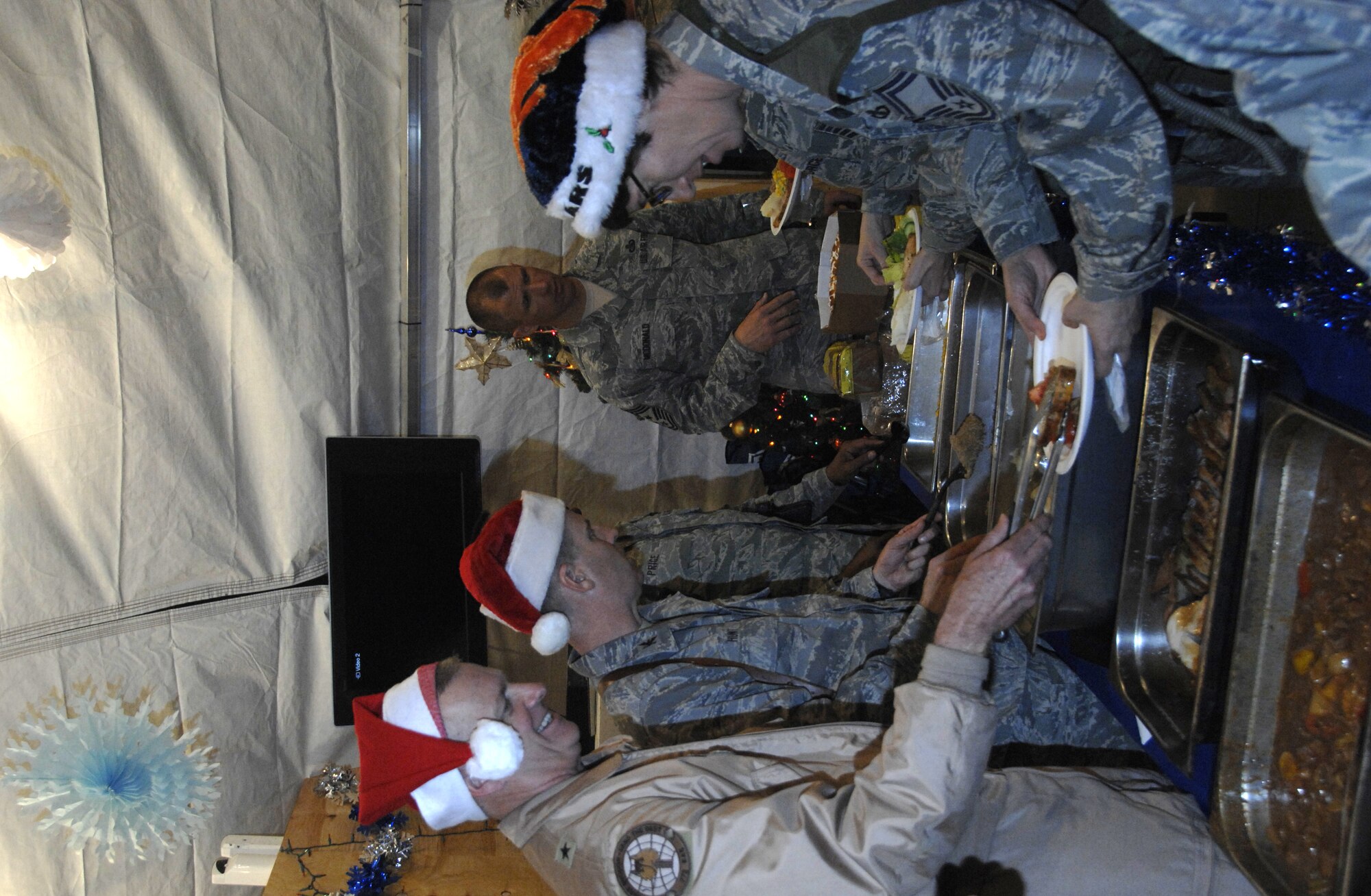 KANDAHAR AIRFIELD, Afghanistan -- Brig. Gen. Guy Walsh, 451st Air Expeditionary Wing commander, and other senior leaders served dinner to Airmen of the 451st AEW during the wing's holiday party Dec. 24. (U.S. Air Force photo/Capt. Kristen D. Duncan)

