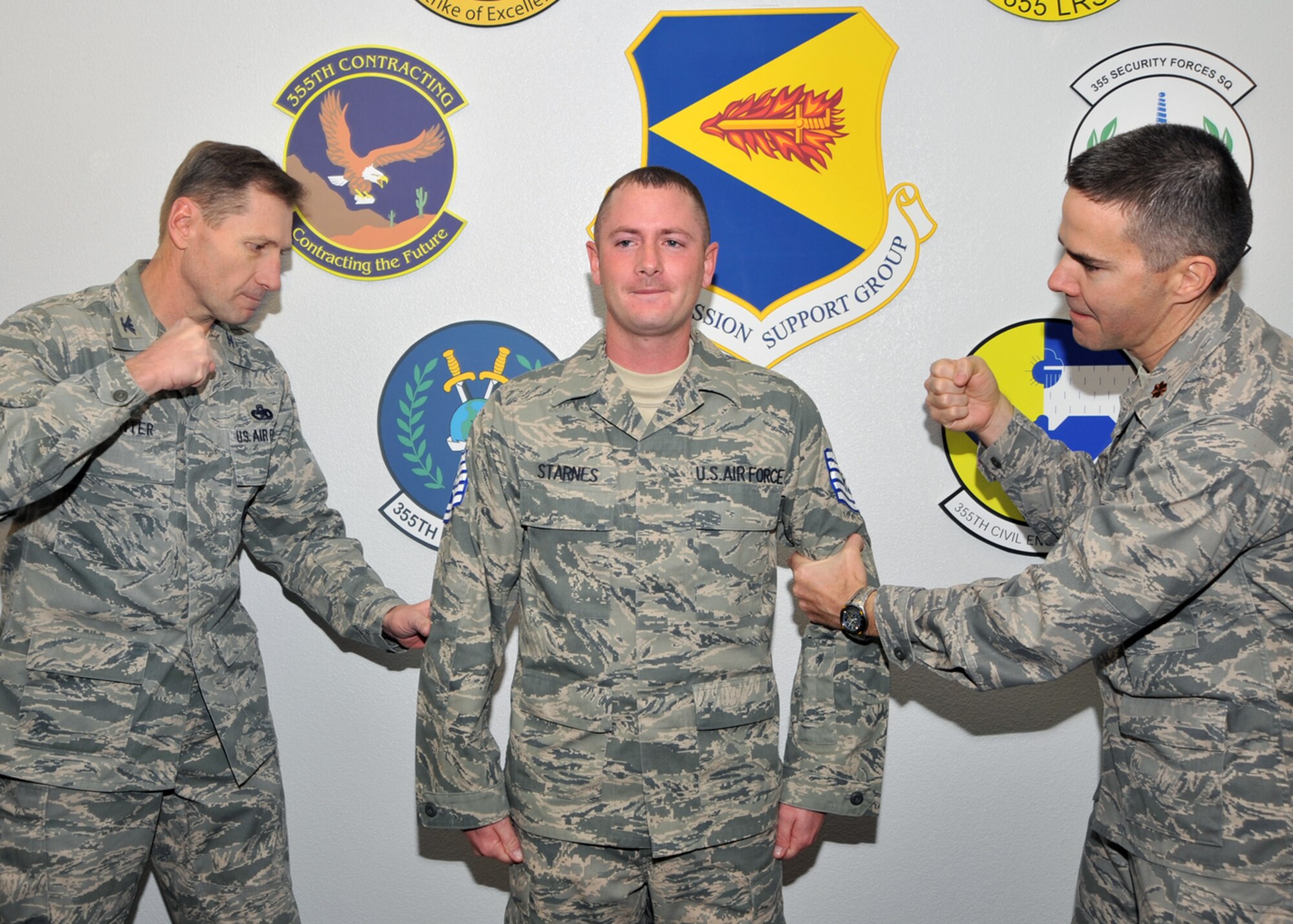Davis-Monthan Air Force Base; Ariz. -- Col. Charles Hunter, 355th Mission Support Group commander, and Maj. Ralph Taylor, 355th Force Support Squadron commander, pin Technical Sgt. stripes on STEP promotee Tech. Sgt. Chris Sterns, 355th Force Support Squadron, here, Dec. 24. Tech. Sgt. Sterns is one of four D-M Airmen selected for promotion under the Stripes for Exceptional Performers Program. (U.S. Air Force photo/Master Sgt. Heather Cabral)