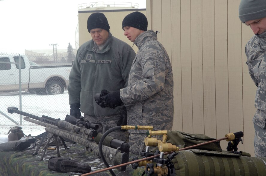 MINOT AIR FORCE BASE -- Chief Master Sergeant of the Air Force James Roy is
shown weapon equipment by Airman First Class Justin Allison, 91st Missile
Security Forces Squadron, during a visit here Dec. 24. Chief Roy's visit
marks his first trip to Minot AFB as CMSAF. He used this unique opportunity
to meet Airmen from both the 5th Bomb Wing and 91st Missile Wing. Chief Roy
is the 16th CMSAF and holds the highest enlisted level of leadership in the
Air Force. (U.S. Air Force photo by Senior Airman Jesse Lopez)
