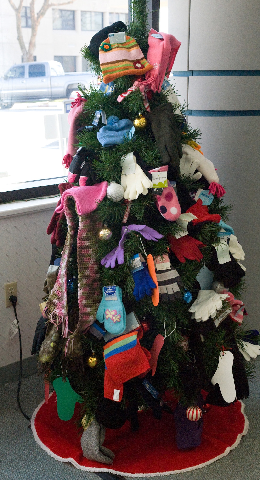 The Mitten Tree at the Dover Air Force Base Library is decorated with more than 75 articles of clothing that will be donated to the local shelter in Dover. (U.S. Air Force photo/Brianne Zimny)
