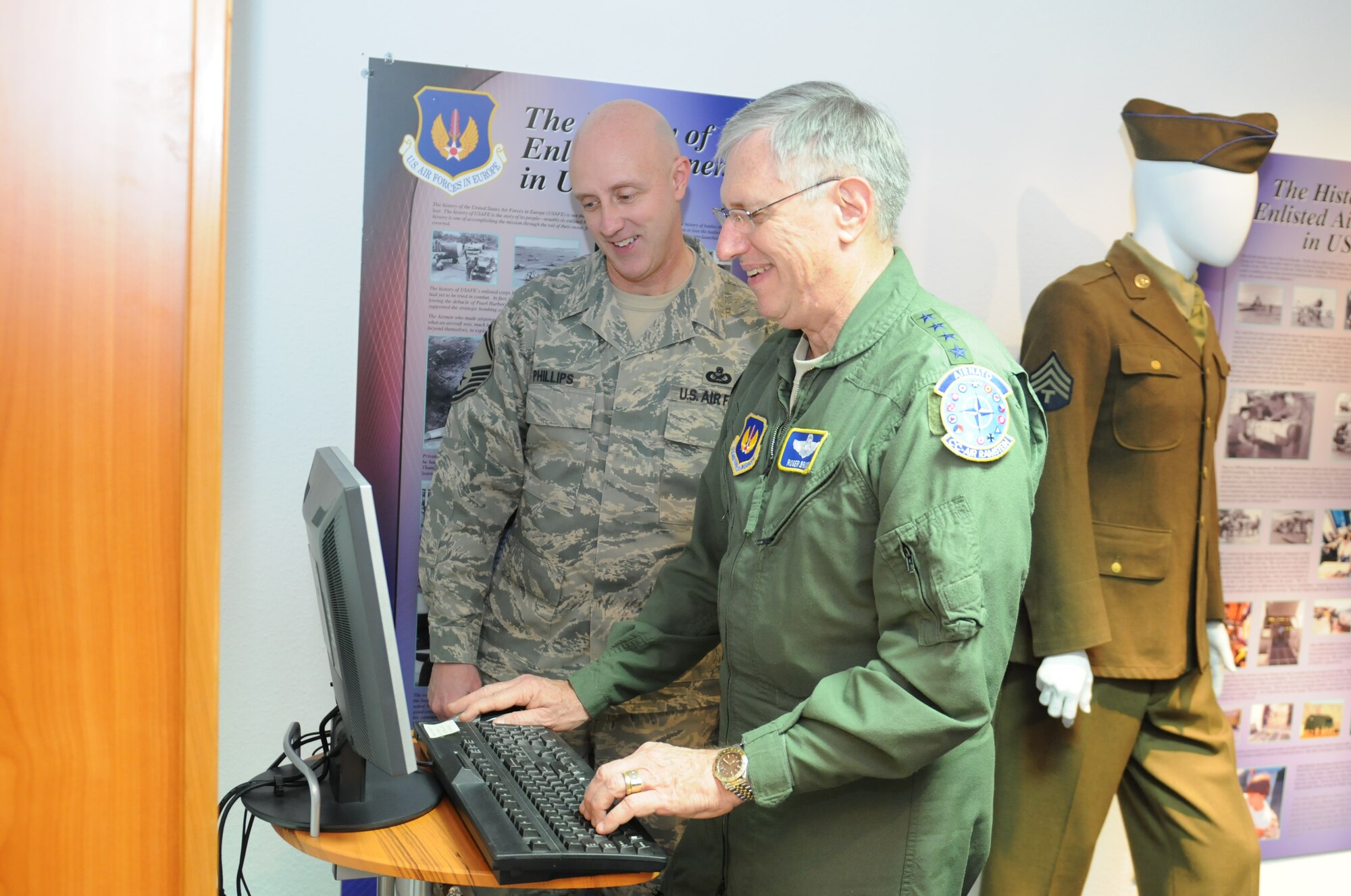 Gen. Roger A. Brady, USAFE commander, registers on the Enlisted Heritage database with the assistance of Senior Master Sgt. J. Lee Phillips, EHC co-chair.  The system documents information about Airmen who have been assigned to USAFE.
