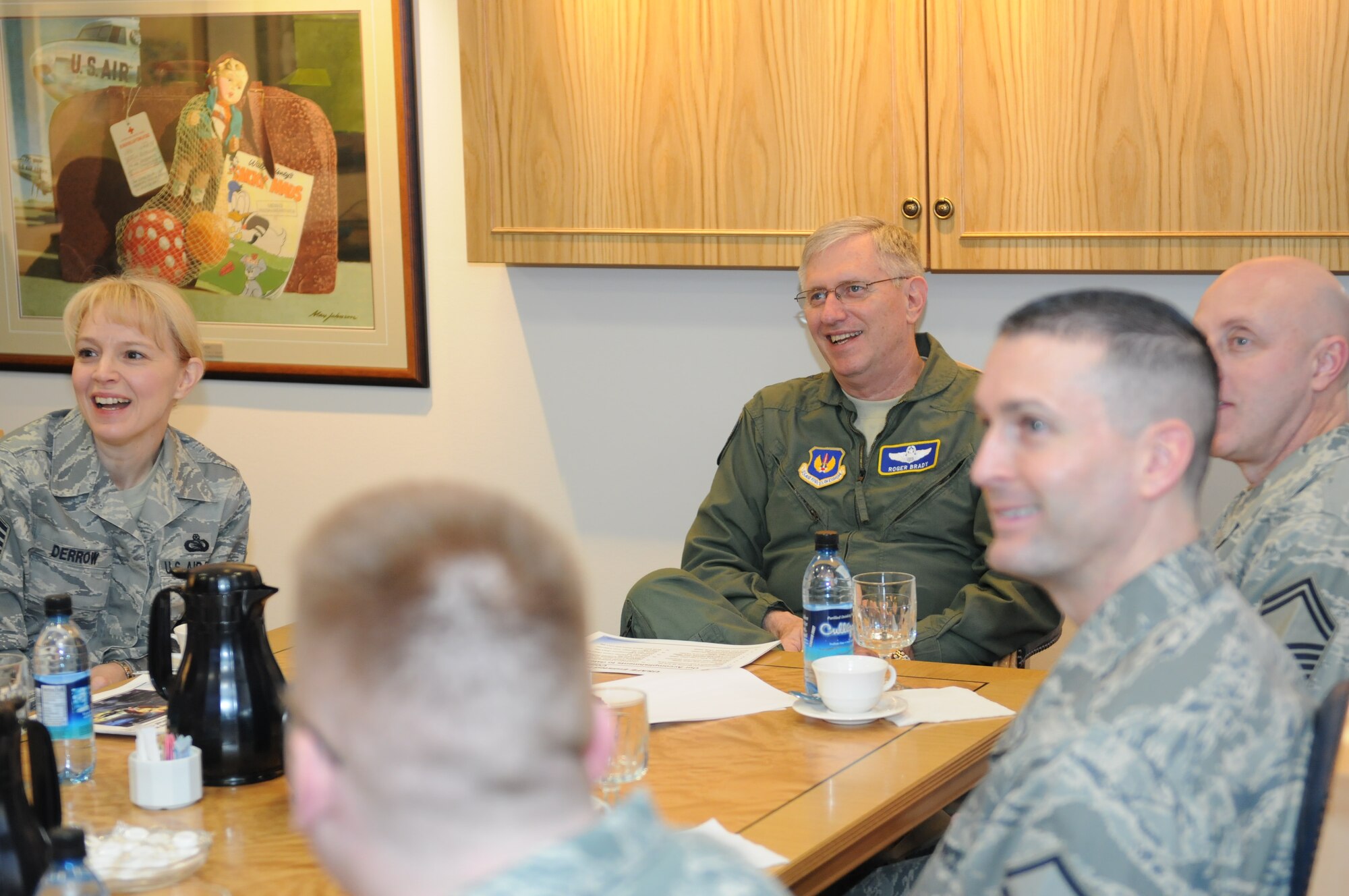 Gen. Roger A. Brady, USAFE commander, center, and Chief Master Sgt. Pamela Derrow, USAFE command chief, listen to a briefing on Enlisted Heritage Committee plans and accomplishments Dec. 18.