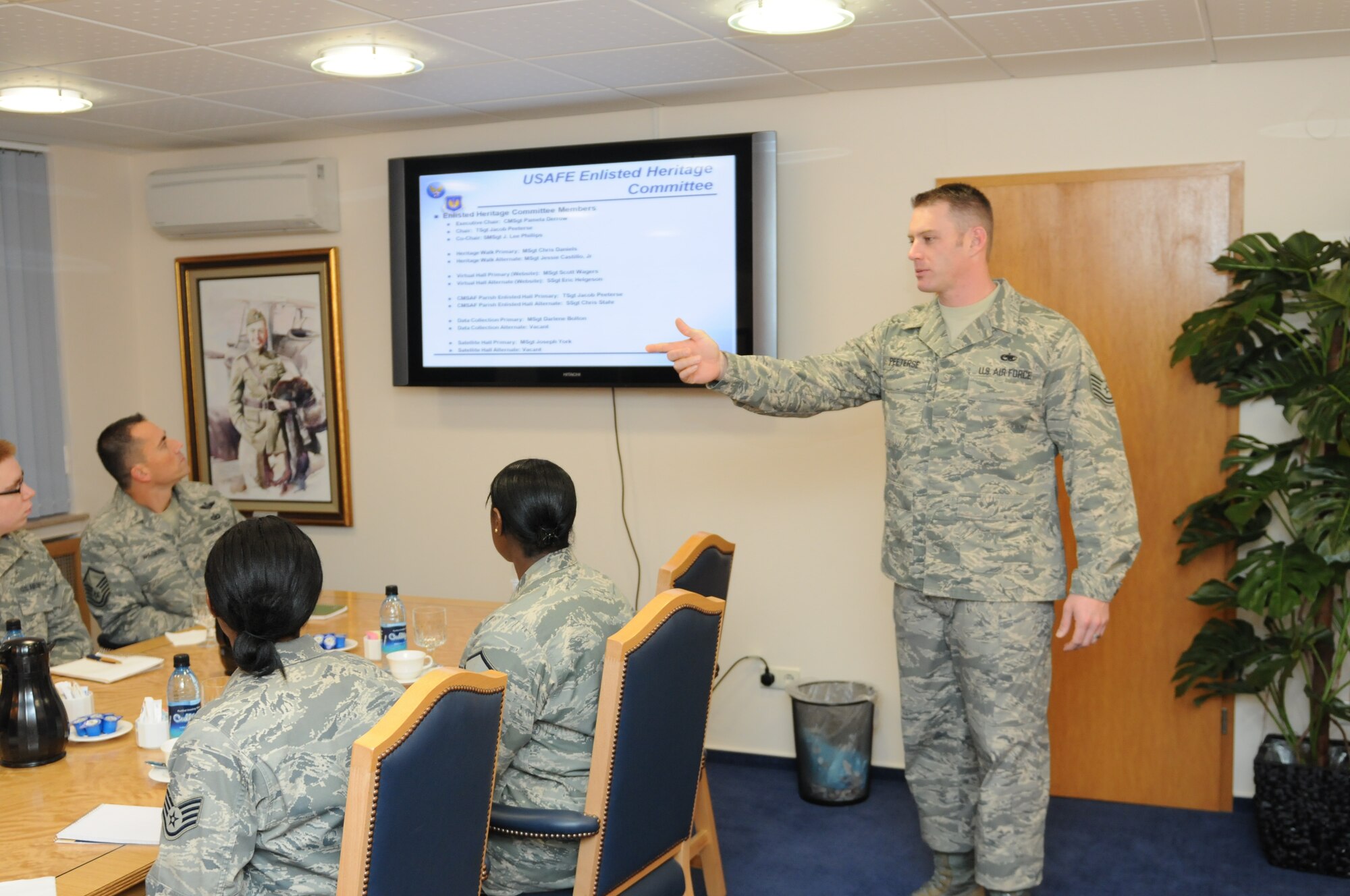 Tech Sgt. Jacob Peeterse, Enlisted Heritage Committee chair, briefs EHC plans and accomplishments to Gen. Roger A. Brady, USAFE commander, and other committee members during a Dec. 18 meeting.