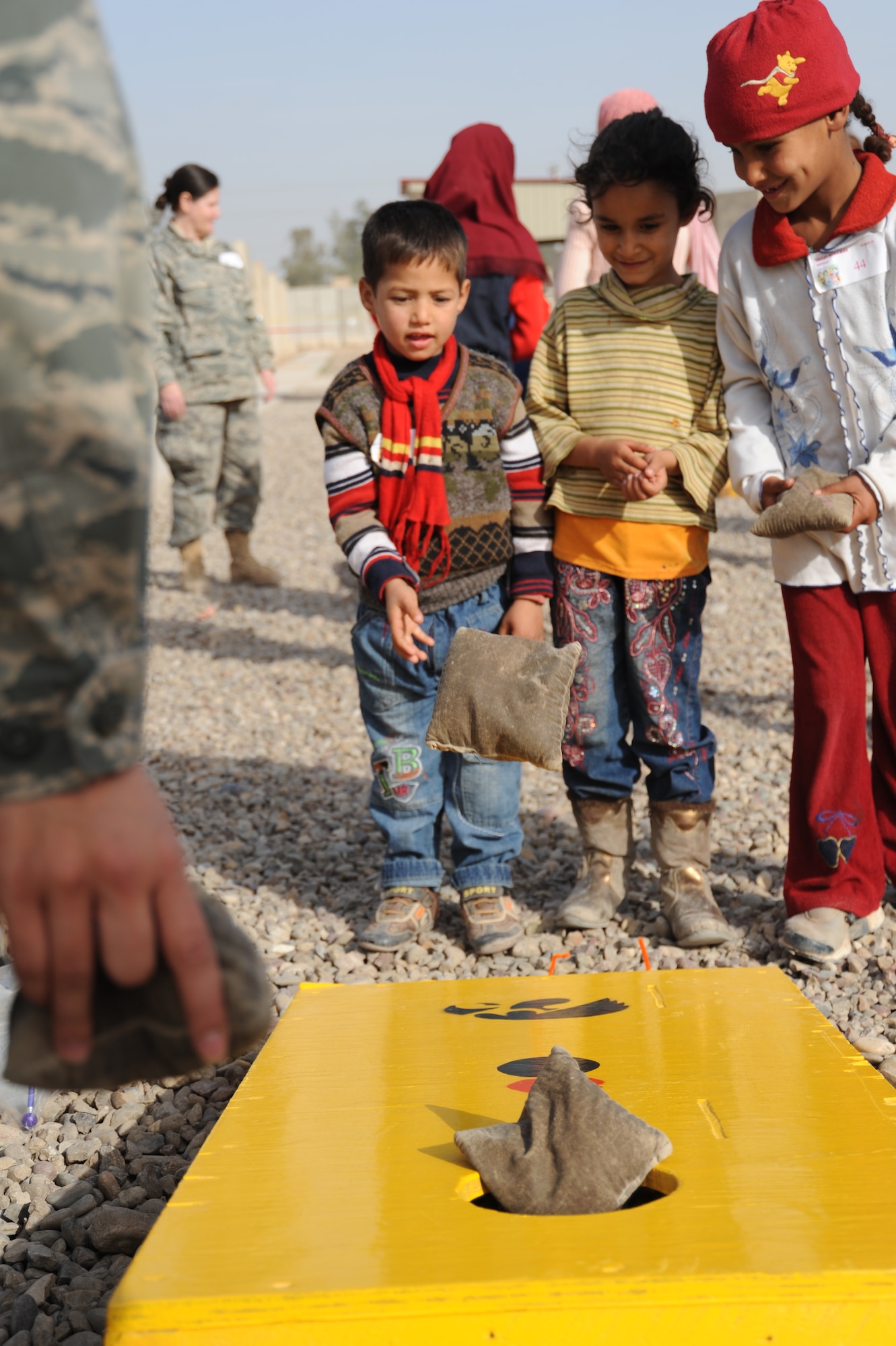 JOINT BASE BALAD, Iraq -- Iraqi children play a bean bag game during Iraqi Kids Day at the H-6 recreation area Dec. 19, 2009. The event marked the fifth of its kind in the last four months, each one focused on educating and entertaining local youths. (U.S. Air Force photo/Senior Airman Christopher Hubenthal)
