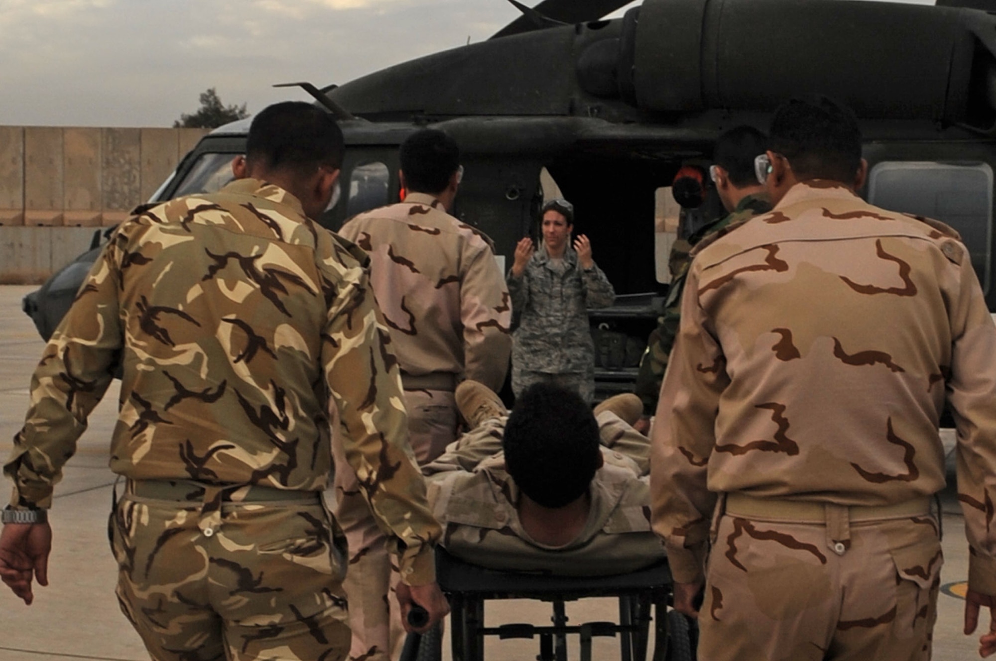 JOINT BASE BALAD, Iraq – Capt. Elizabeth Hoettels of the 332nd Expeditionary Medical Group guides Iraqi air force members through medical evacuation training Dec. 21, 2009, at the Air Force Theater Hospital. The purpose of the training is to help the Ministry of Defense strengthen its health care system for Iraqi troops. (U.S. Air Force photo/Senior Airman Brittany Y. Bateman)