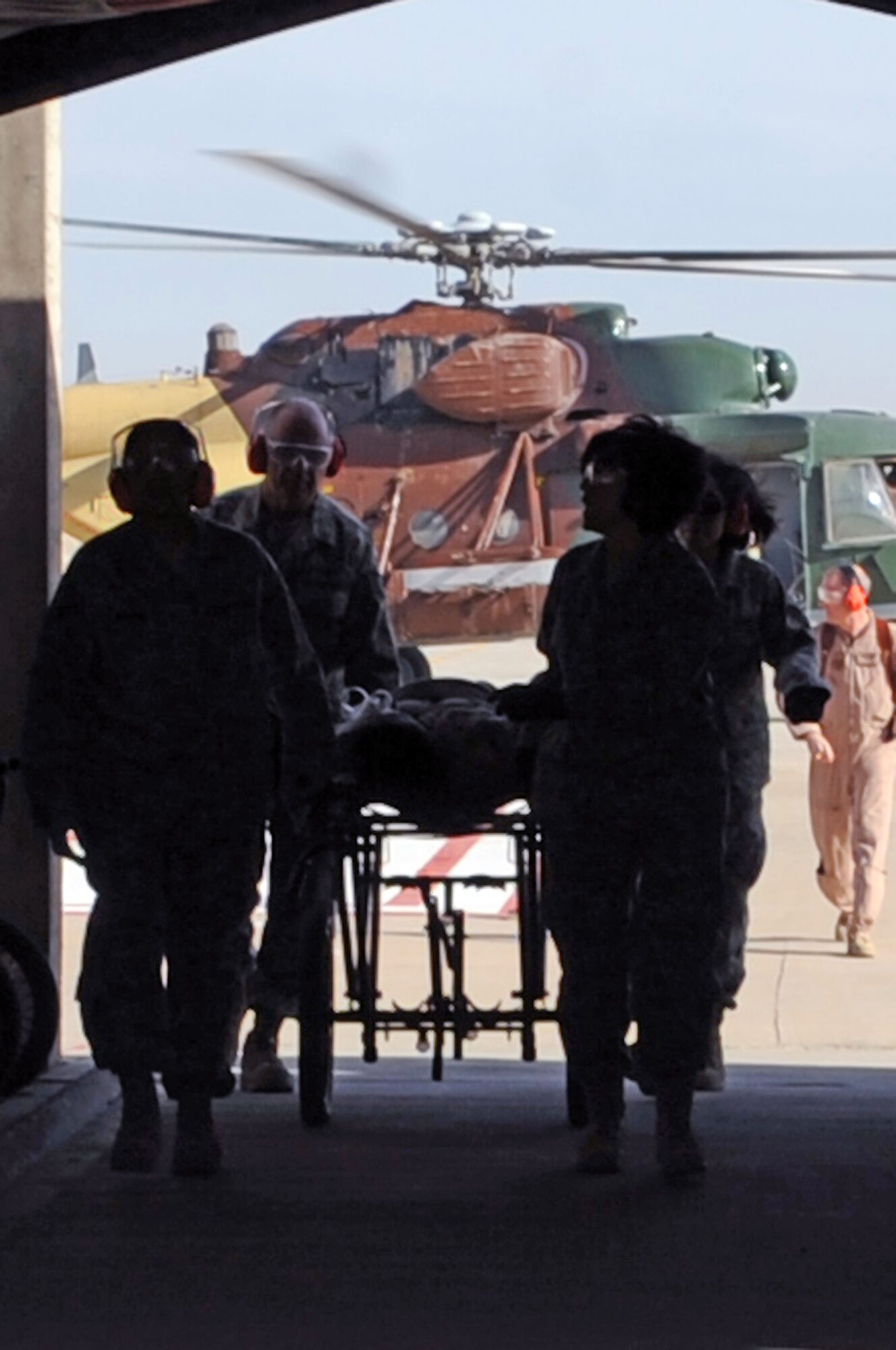 JOINT BASE BALAD, Iraq – Members of the 332nd Expeditionary Medical Group transport a mock patient from an Iraqi helicopter during medical evacuation training for the Iraqi air force Dec. 21, 2009. The purpose of the training is to help the Ministry of Defense strengthen its health care system for Iraqi troops. (U.S. Air Force photo/Senior Airman Brittany Y. Bateman)