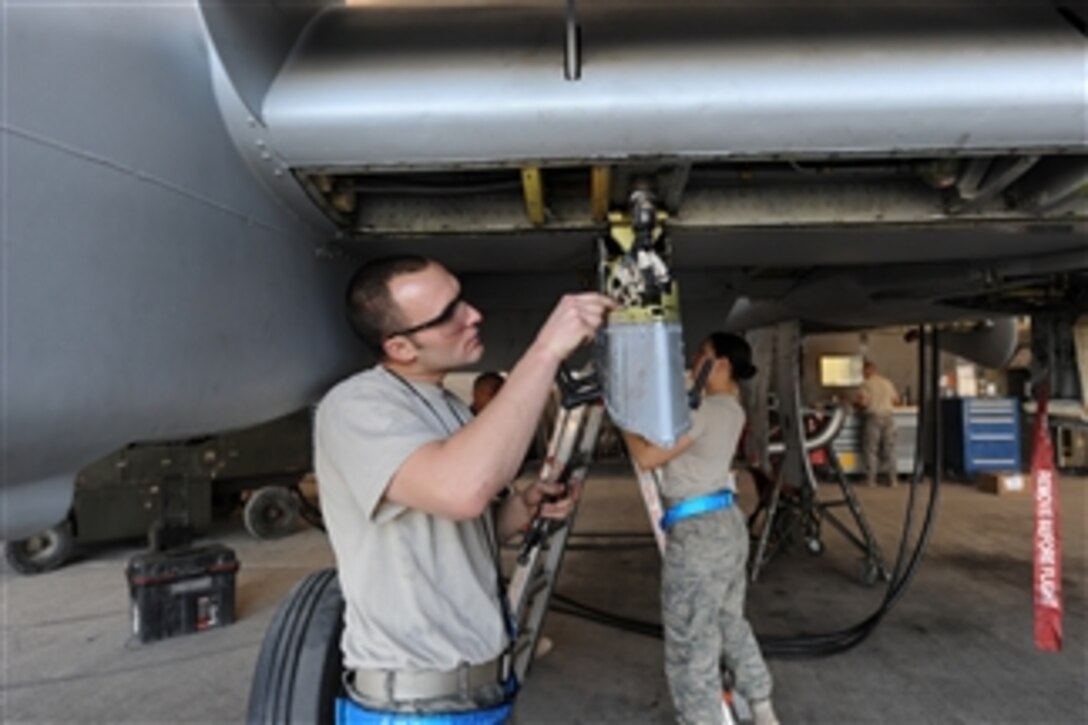 U.S. Air Force Staff Sgt. Ryan Vandenbrand and Senior Airman Sophia Ramallo, both with the 451st Expeditionary Maintenance Squadron, inspect an A-10C Thunderbolt II aircraft at Kandahar Airfield, Afghanistan, on Dec. 27, 2009.  The A-10 is specifically designed to provide close air support for U.S. and coalition ground forces.  
