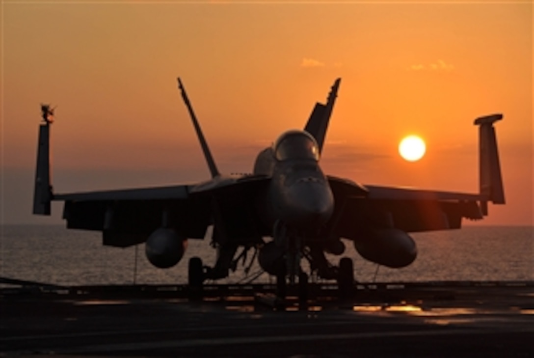 A U.S. Navy F/A-18E Super Hornet aircraft assigned to Strike Fighter Squadron 14 sits tied-down on the flight deck of the aircraft carrier USS Nimitz (CVN 68) while underway in the North Arabian Sea on Dec. 18, 2009.  The Nimitz Carrier Strike Group is on deployment to the U.S. 5th Fleet area of operations.  