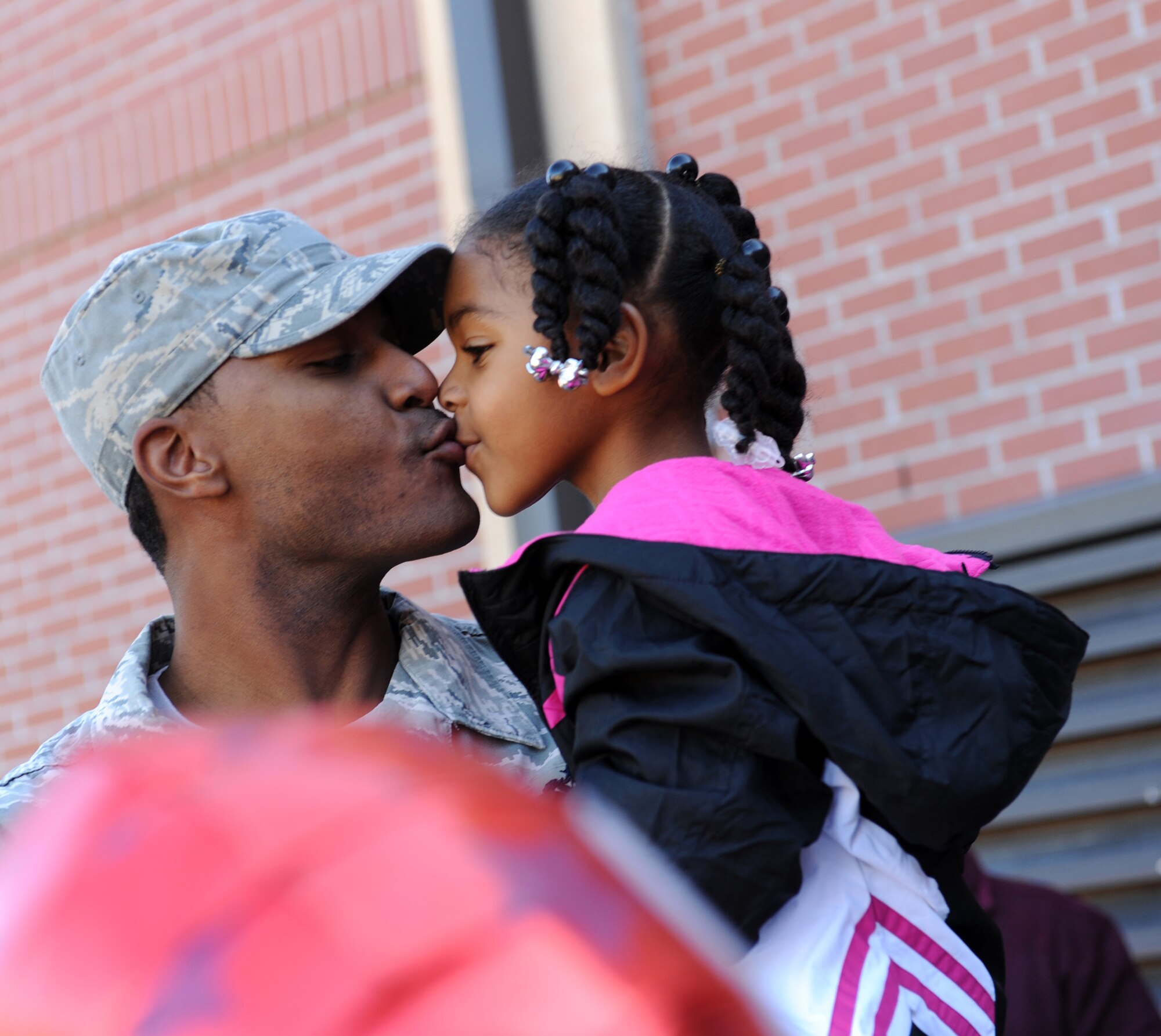 MOODY AIR FORCE BASE, Ga. -- Tech. Sgt. Alvin Dyer, 23rd Civil Engineering Squadron heating, ventilation and air conditioning NCO in-charge, gives his daughter, Cassidy, a kiss after he was  promoted to master sergeant under the Stripes for Exceptional Performers program here Dec. 29. Each fiscal year, a limited number of enlisted Air Force personnel with exceptional potential may be promoted to the grades of staff sergeant through master sergeant under the STEP program. (U.S. Air Force photo by Airman 1st Class Benjamin Wiseman)