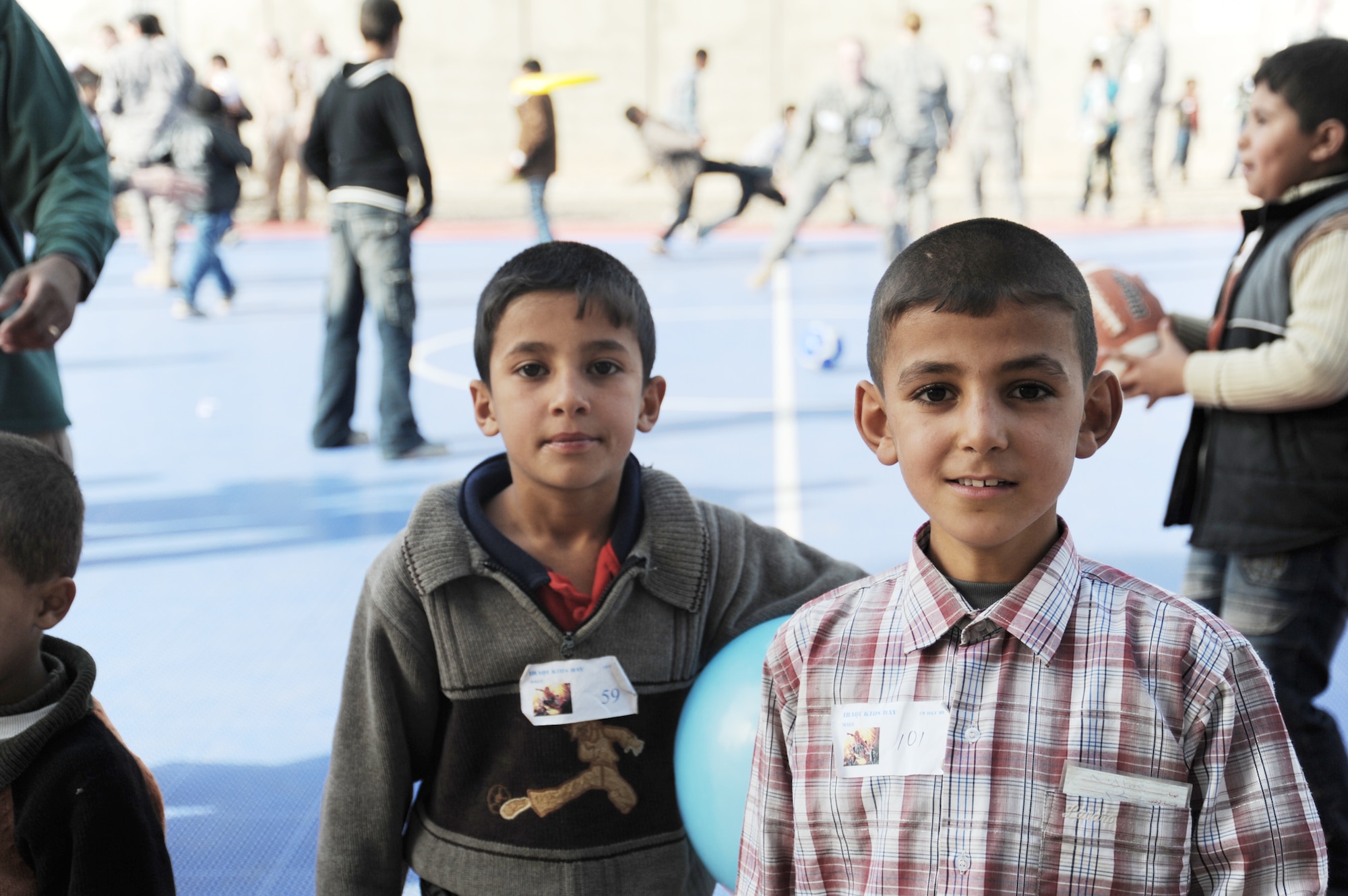 Two Iraqi boys pose for a photo they requested during Iraqi Kids Day Dec. 19, 2009, at Joint Base Balad, Iraq. The event was part of the ongoing base effort to directly engage the local populace, bringing kids from neighboring villages together with U.S. military volunteer mentors for a day of fun, games and culture sharing. (U.S. Air Force photo/Senior Airman Christopher Hubenthal)
