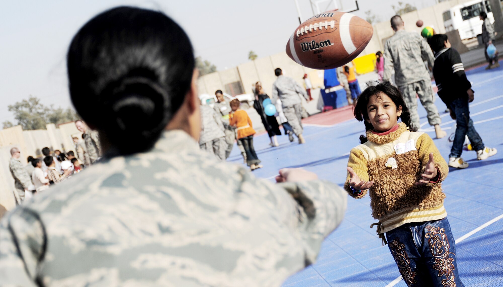Airman 1st Class Valika Lagimaina plays with an Iraqi child during Iraqi Kids Day Dec. 19, 2009, at Joint Base Balad, Iraq. The day provided servicemembers the opportunity to interact with and mentor local children. Airman Lagimaina is from the 332nd Expeditionary Logistics Readiness Squadron. (U.S. Air Force photo/Senior Airman Christopher Hubenthal)