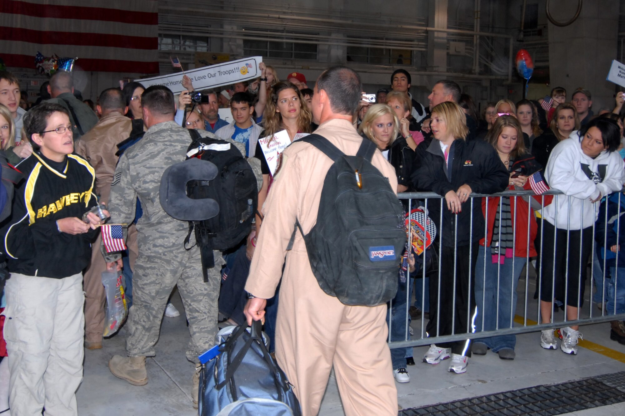 Over five hundred family members, friends, and well wishers await the arrival of their loved ones in the west hanger of the 132nd Fighter Wing, Des Moines, Iowa on Christmas Eve day 2009. Unit members were retuning from an Aerospace Expeditionary Force deployment to Joint Base Balad, Iraq. Aircraft diverts, rain, sleet, and the third wave of snow to hit Iowa, didn?t dampen the spirits of those waiting. (U.S. Air Force/Senior Master Sgt. Tim Day) (Released)