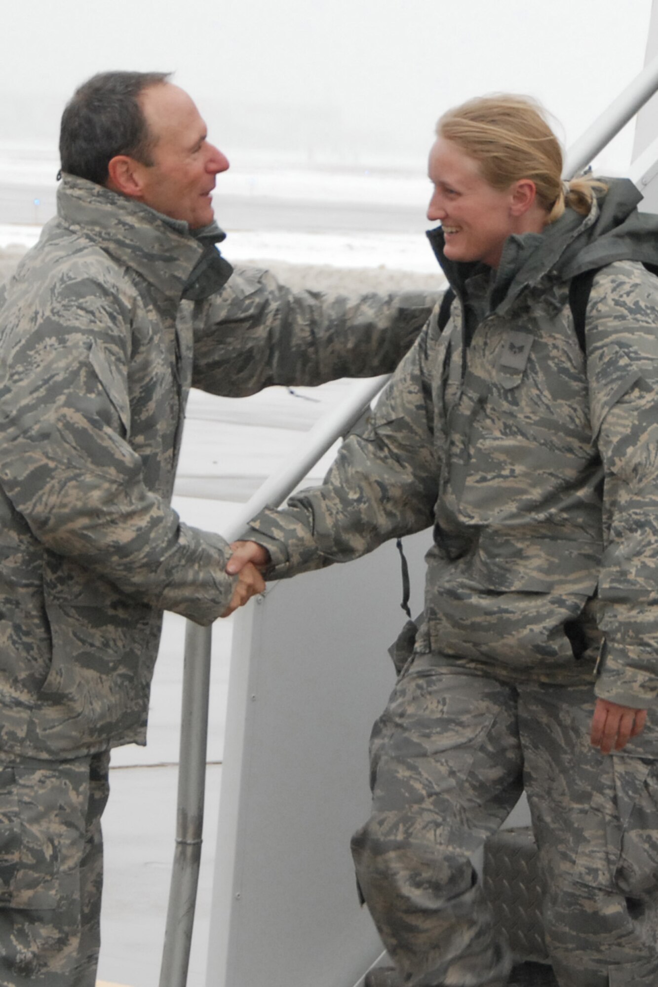 Brig. Gen. Gregory Schwab, Deputy Adjutant General  Air, Iowa National Guard, welcomes home Senior Airman Kelly Farris. Senior Airman Harris along with 250 other unit members returned to the 132nd Fighter Wing, Des Moines, Iowa Christmas Eve, 12/24/2009, after completing an AEF rotation to Joint Base Balad, Iraq. (U.S. Air Force/Senior Master Sgt. Tim Day)(released)