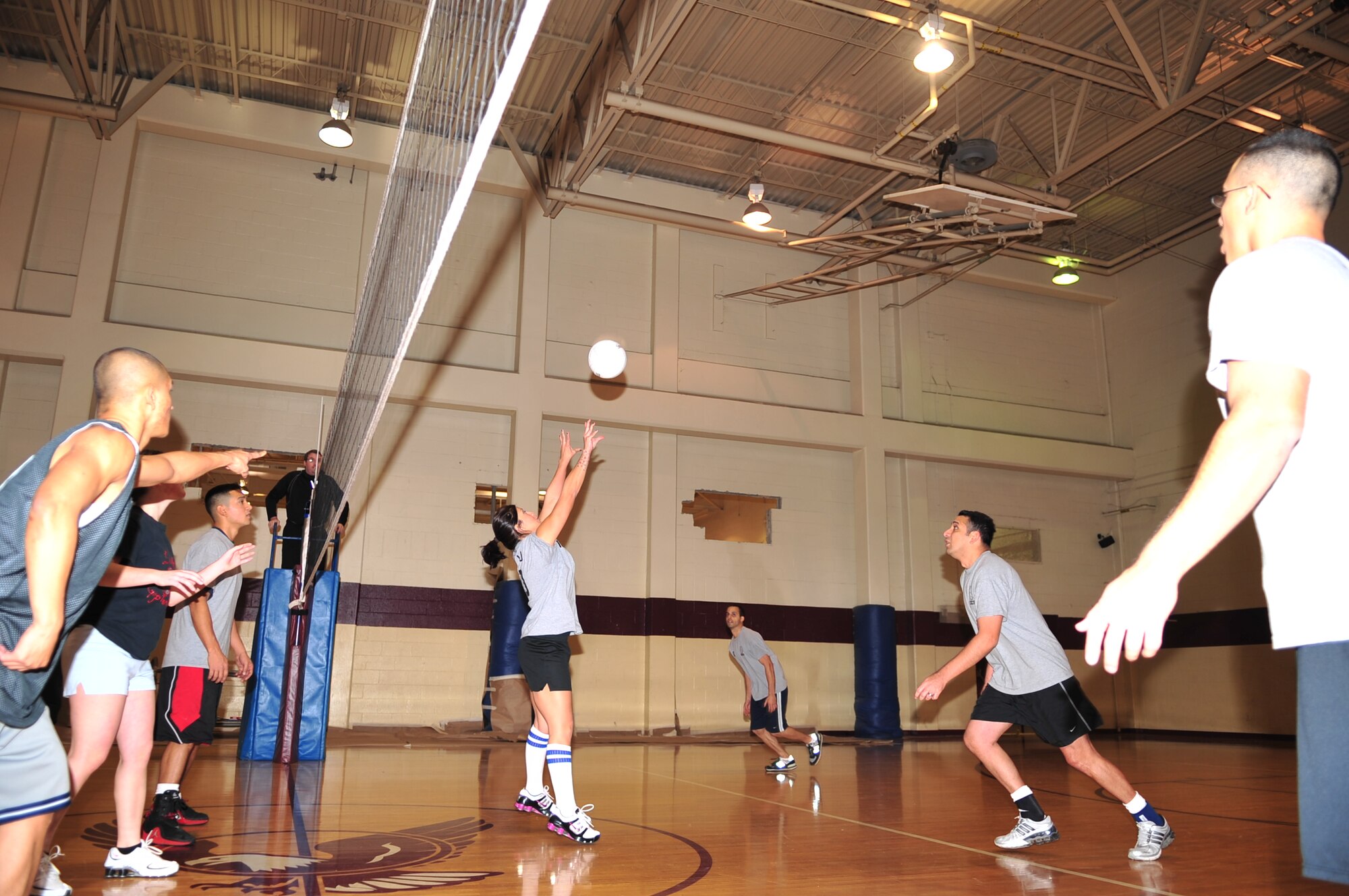 Lucy Lindstamer, 4th Civil Engineers Squadron, sets the ball for one of her team mates to spike during an intramural volleyball championship game on Seymour Johnson Air Force Base, N.C., Dec. 21, 2009. Each team had a win on the board going into the final game where the 4th CES were victorious. (U.S. Air Force photo/Airman 1st Class Rae Perry)