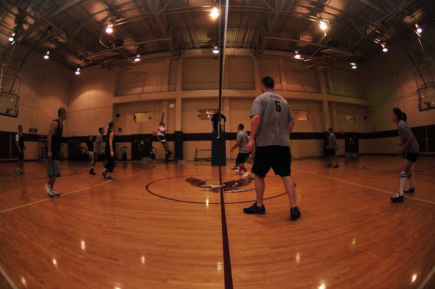Members of the 4th Civil Engineers Squadron and 4th Logistical Readiness Squadron compete during an intramural volleyball championship game on Seymour Johnson Air Force Base, N.C., Dec. 21, 2009. The teams played three 25-point games before the 4th CES team earned the championship title. (U.S. Air Force photo/Airman 1st Class Rae Perry)