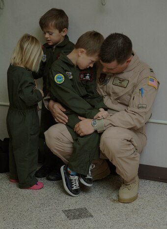 Capt. Adam Sereika comforts his son prior to departure for a four month deployment on Dec. 28 at the passenger terminal here. The deployment is destined in the Middle East in support of Operation Iraqi Freedom and Operation Enduring Freedom. Capt. Sereika is a reserve C-17 pilot assigned to the 701st Airlift Squadron here. (U.S. Air Force photo/Airman 1st Class Lauren Main)