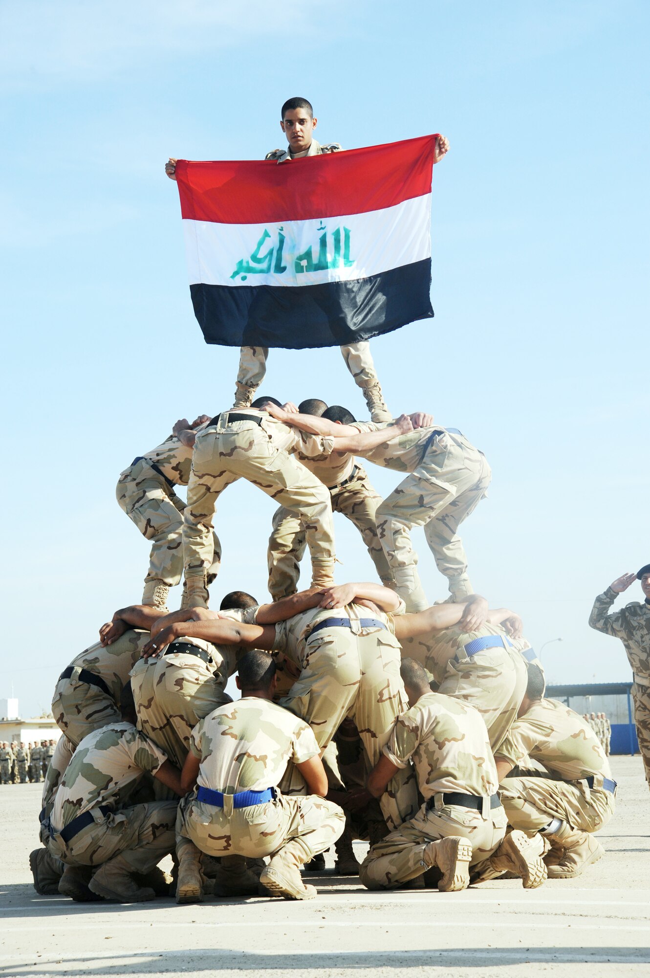 Iraqi air force recruits build a human pyramid during their graduation ceremony from the basic military training Top Off course at the Iraqi Air Force Training School Dec. 28, 2009, at Camp Taji, Iraq. The Top Off course teaches recruits about rank structure, leadership and what kind of benefits they will receive. (U.S. Air Force photo/Master Sgt. Trish Bunting)