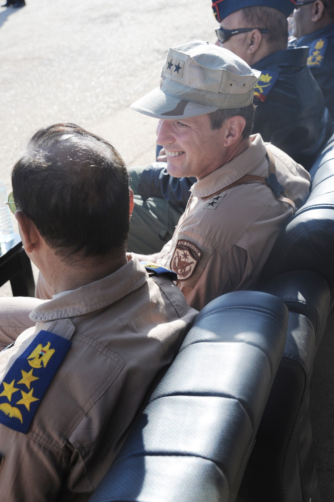 Maj. Gen. Robert Kane watches a pass in review parade during a basic military training Top Off course graduation ceremony at the Iraqi Air Force Training School Dec. 28, 2009, at Camp Taji, Iraq. General Kane observed more than 330 Iraqi air force recruits graduate from the course. General Kane is the Air Force Director for the Iraq Training and Advisory Mission. (U.S. Air Force photo/Master Sgt. Trish Bunting)