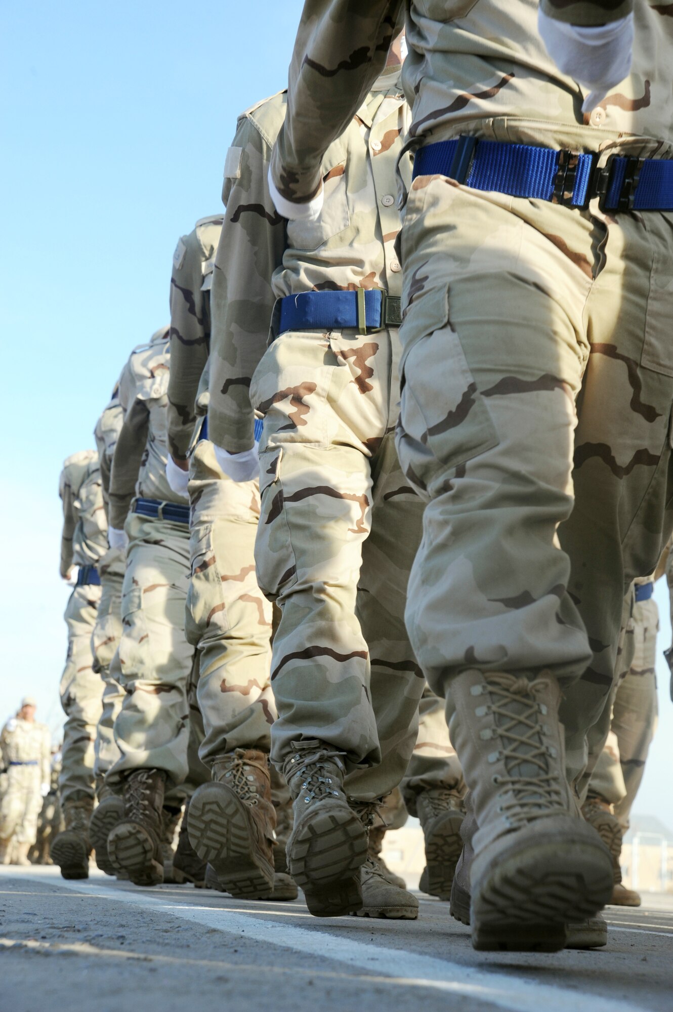 Iraqi air force recruits march in a pass in review parade during their graduation ceremony from the basic military training Top Off course at the Iraqi Air Force Training School Dec. 28, 2009, at Camp Taji, Iraq. The staff incorporated discipline, marching and drill during the morning sessions and academics in the afternoon. (U.S. Air Force photo/Master Sgt. Trish Bunting)