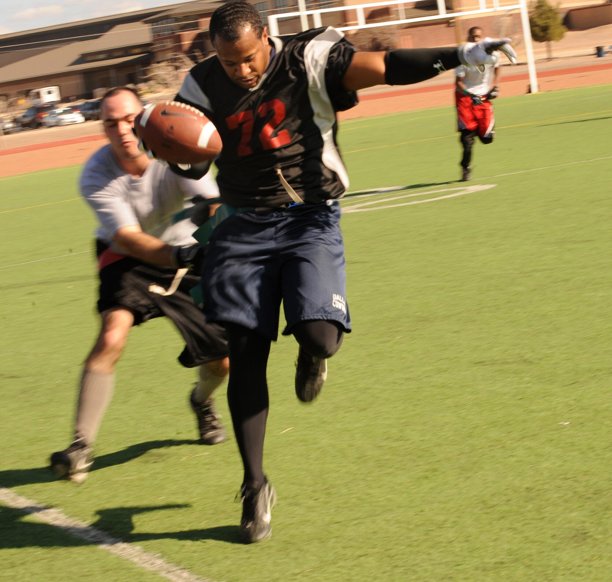 HOLLOMAN AIR FORCE BASE, N.M. -- Willie Green, of the 49th Aircraft Maintenance Squadron, tip-toes down the sideline during the Flag Football Championship game Dec. 19. The 49th AMXS went 3 - 2 in the double elimination tournament to make it to the championship, but fell by 7 points in the final game against the 49th Maintenance Squadron. (U.S. Air Force photo by Airman 1st Class Sondra Escutia)