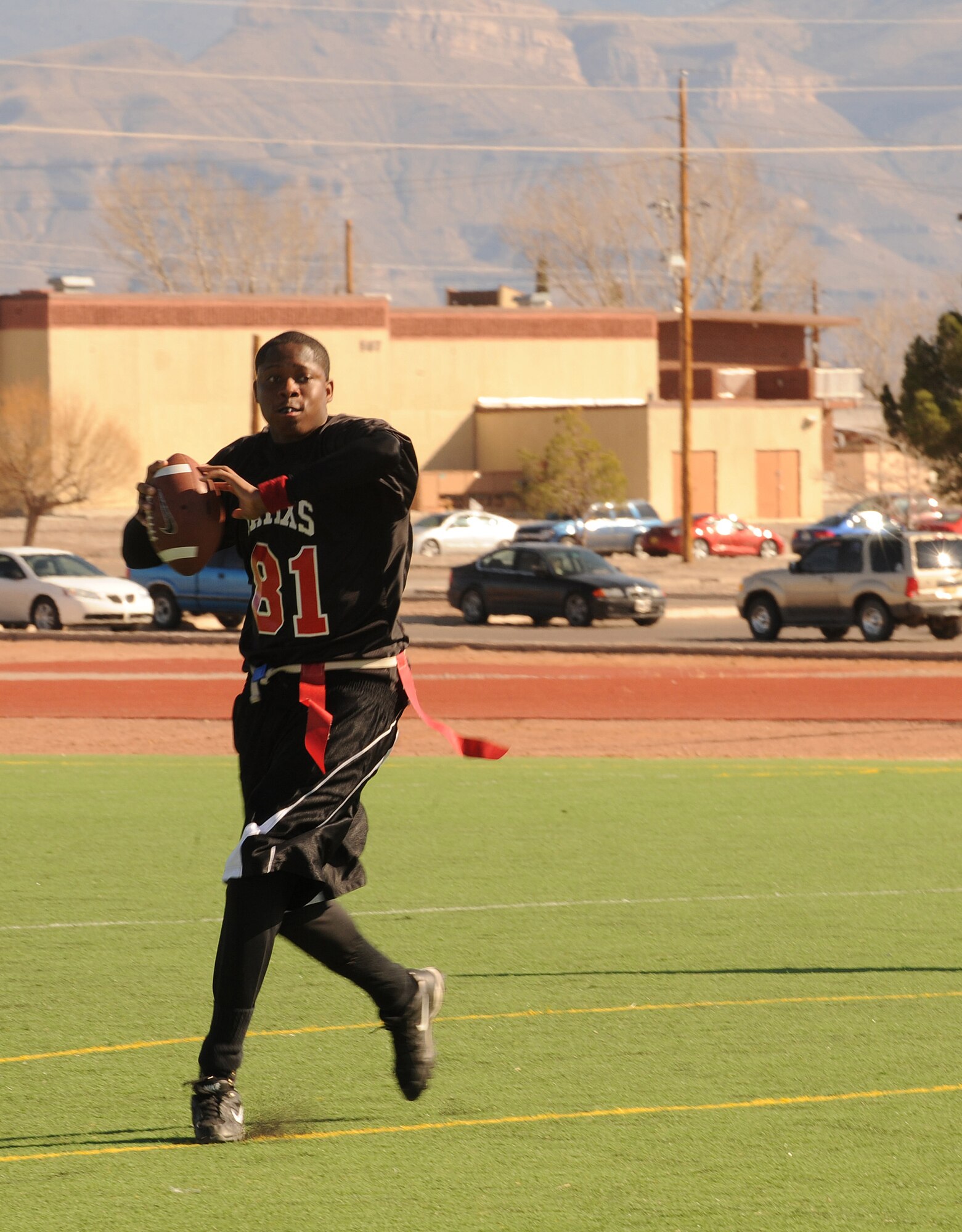 HOLLOMAN AIR FORCE BASE, N.M. -- Ernest Fishburne, quarterback for the 49th Aircraft Maintenance Squadron, drops back to look for an open receiver during the Flag Football Championship game Dec. 19. The 49th AMXS were seeded second out of 11 teams in the tournament, but lost the final game by 7 points against the 49th Maintenance Squadron. (U.S. Air Force photo by Airman 1st Class Sondra Escutia)
