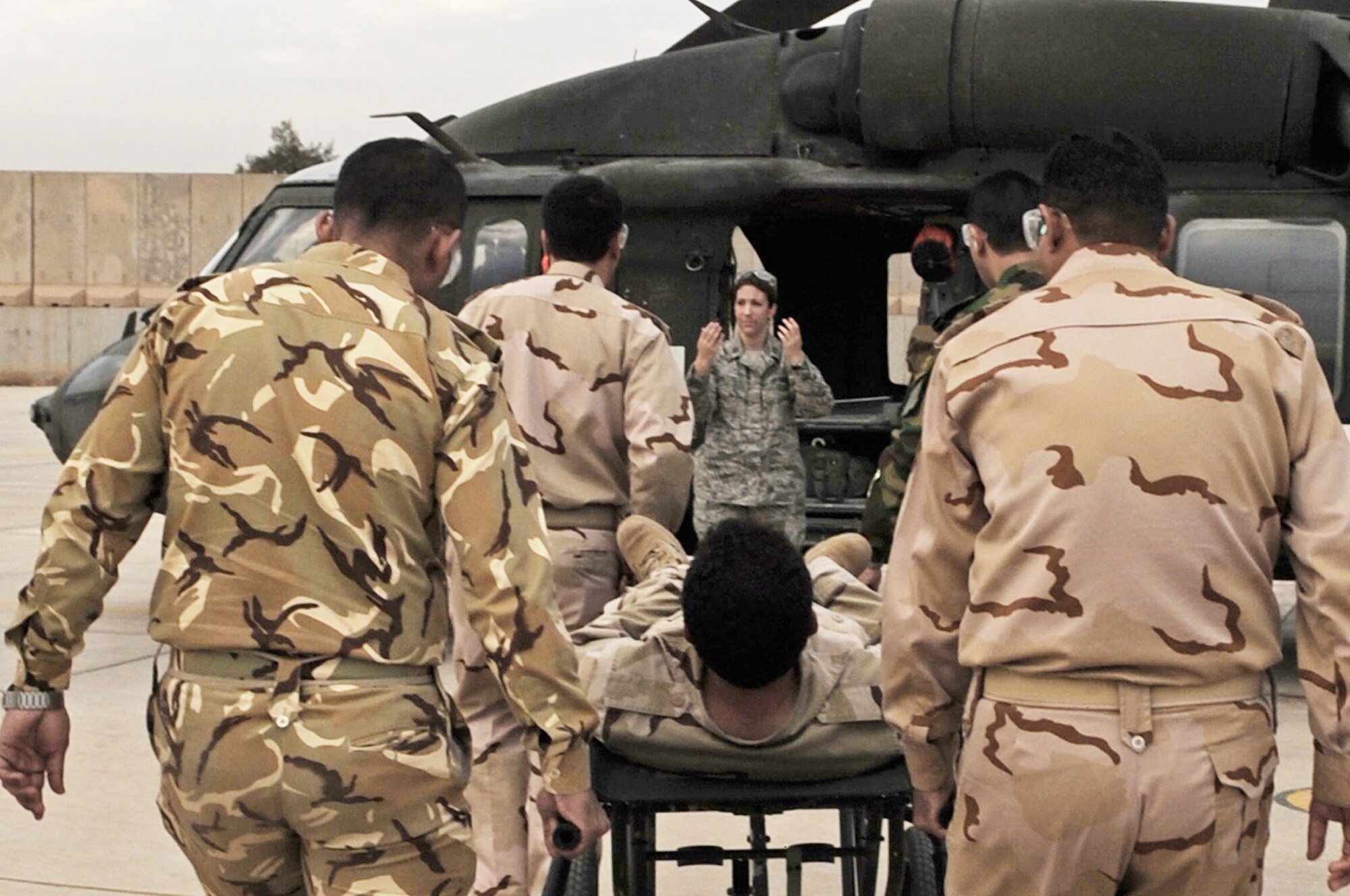 Capt. Elizabeth Hoettels guides Iraqi air force members through medical evacuation training Dec. 21, 2009, at the Air Force Theater Hospital, at Joint Base Balad, Iraq. The purpose of the training is to help Ministry of Defense officials strengthen their health care system for Iraqi troops. Captain Hoettels is from the 332nd Expeditionary Medical Group. (U.S. Air Force photo/Senior Airman Brittany Bateman)