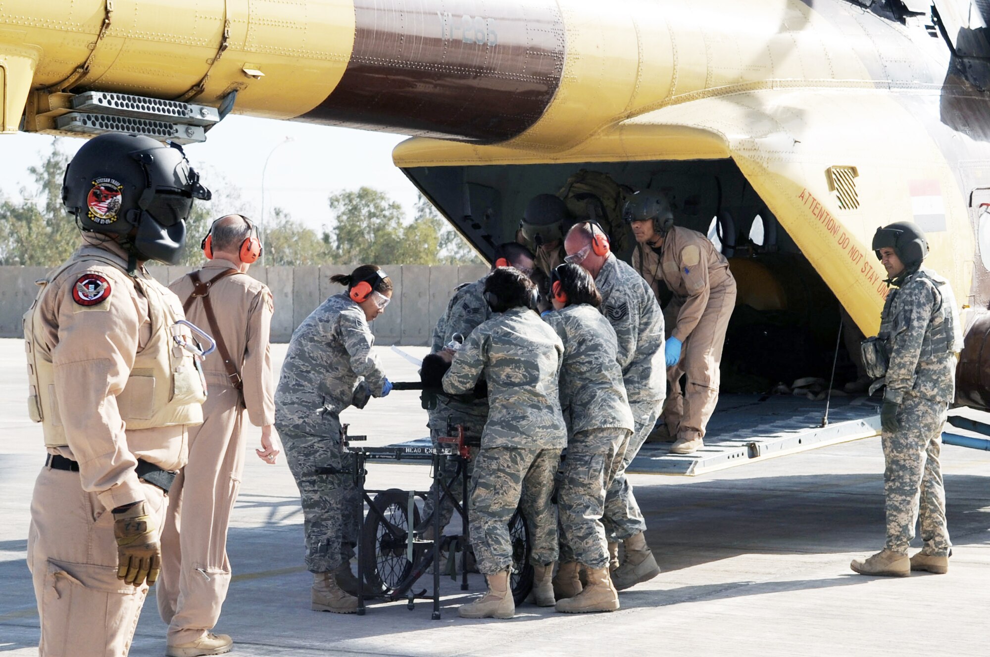 Airmen from the 332nd Expeditionary Medical Group unload a patient from an Iraqi helicopter during medical evacuation training for the Iraqi air force Dec. 21, 2009, at Joint Base Balad, Iraq. The purpose of the training is to help Ministry of Defense officials strengthen their health care system for Iraqi troops. (U.S. Air Force photo/Senior Airman Brittany Bateman)