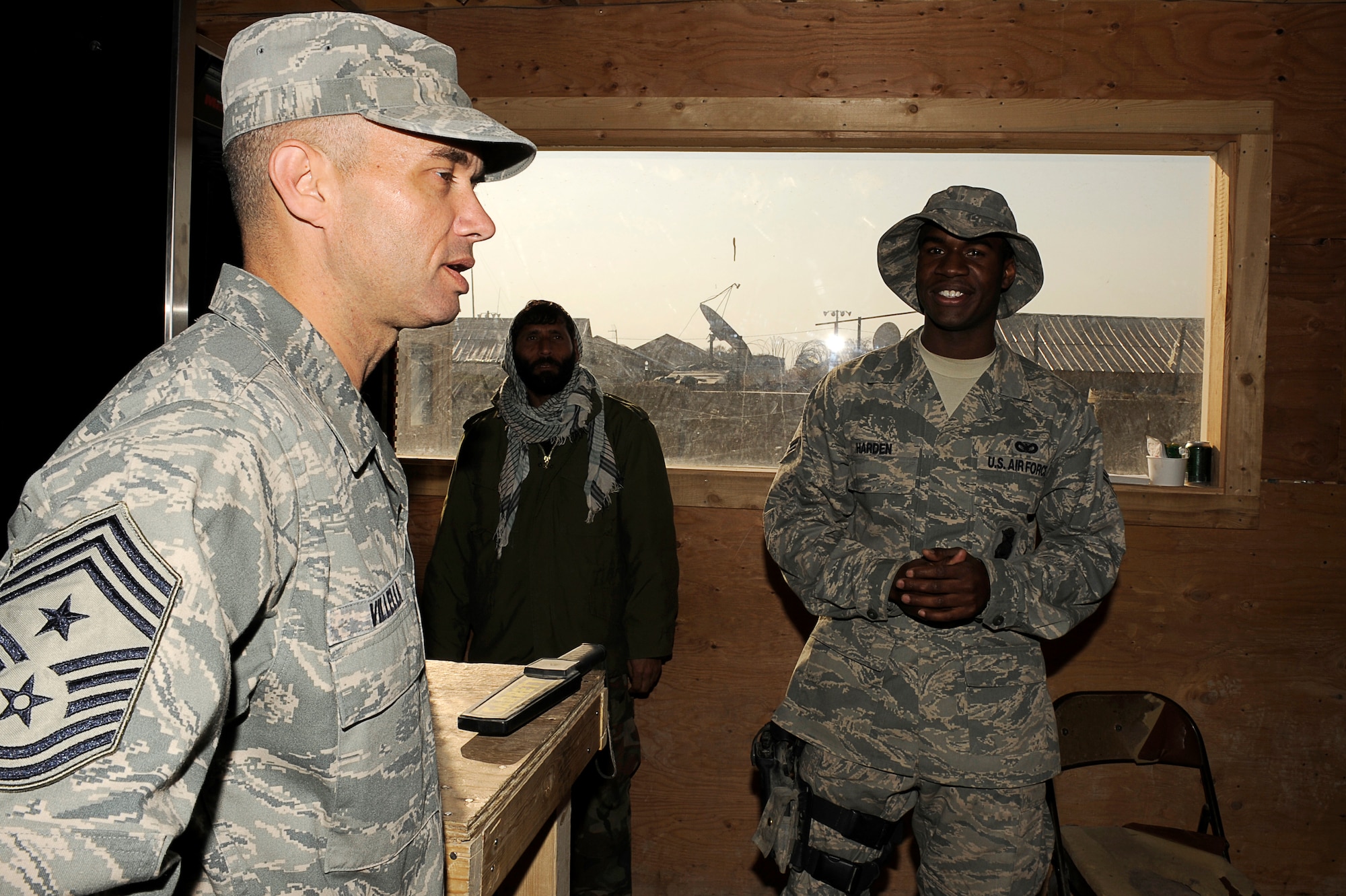 BAGRAM AIRFIELD, Afghanistan--U.S. Air Forces Central, Command Chief Master Sgt. Mark Villella talks with Airman 1st Class Marcus Harden, 455th Air Expeditionary Wing, Security Forces Squadron.  Chief Villella toured the work areas of Airmen during his trip to Bagram Airfield, Dec. 30, 2009. (U.S. Air Force photo by: Tech. Sgt. Jeromy K. Cross)
