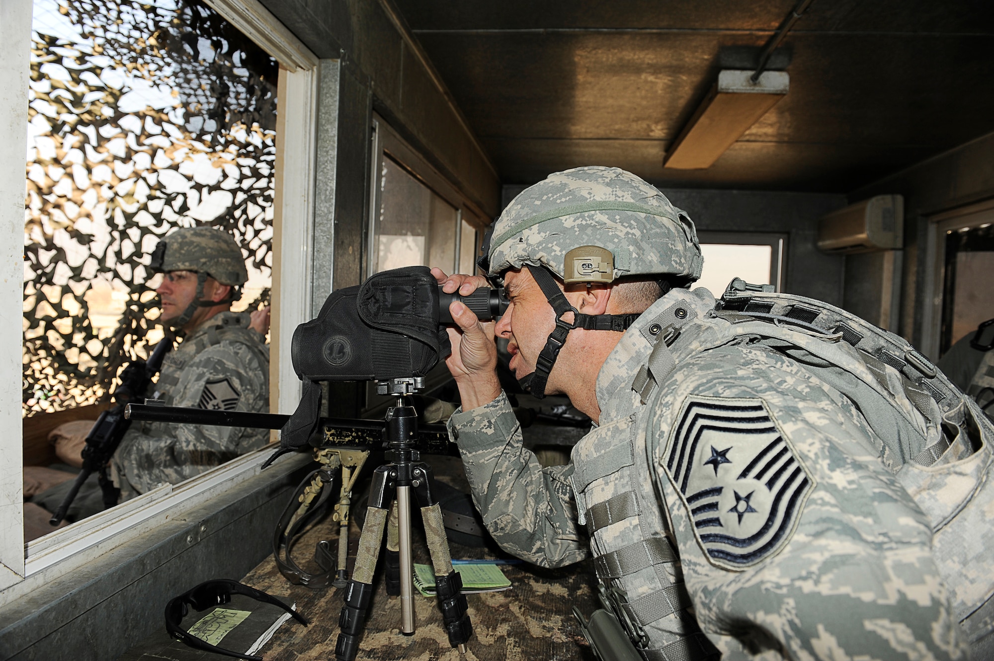 BAGRAM AIRFIELD Afghanistan--U.S. Air Forces Central, Command Chief Master Sgt. Mark Villella looks though a spotting scope.  Chief Villella toured the work areas of Airmen during his trip to Bagram Airfield, Dec. 30, 2009. (U.S. Air Force photo by: Tech. Sgt. Jeromy K. Cross)
