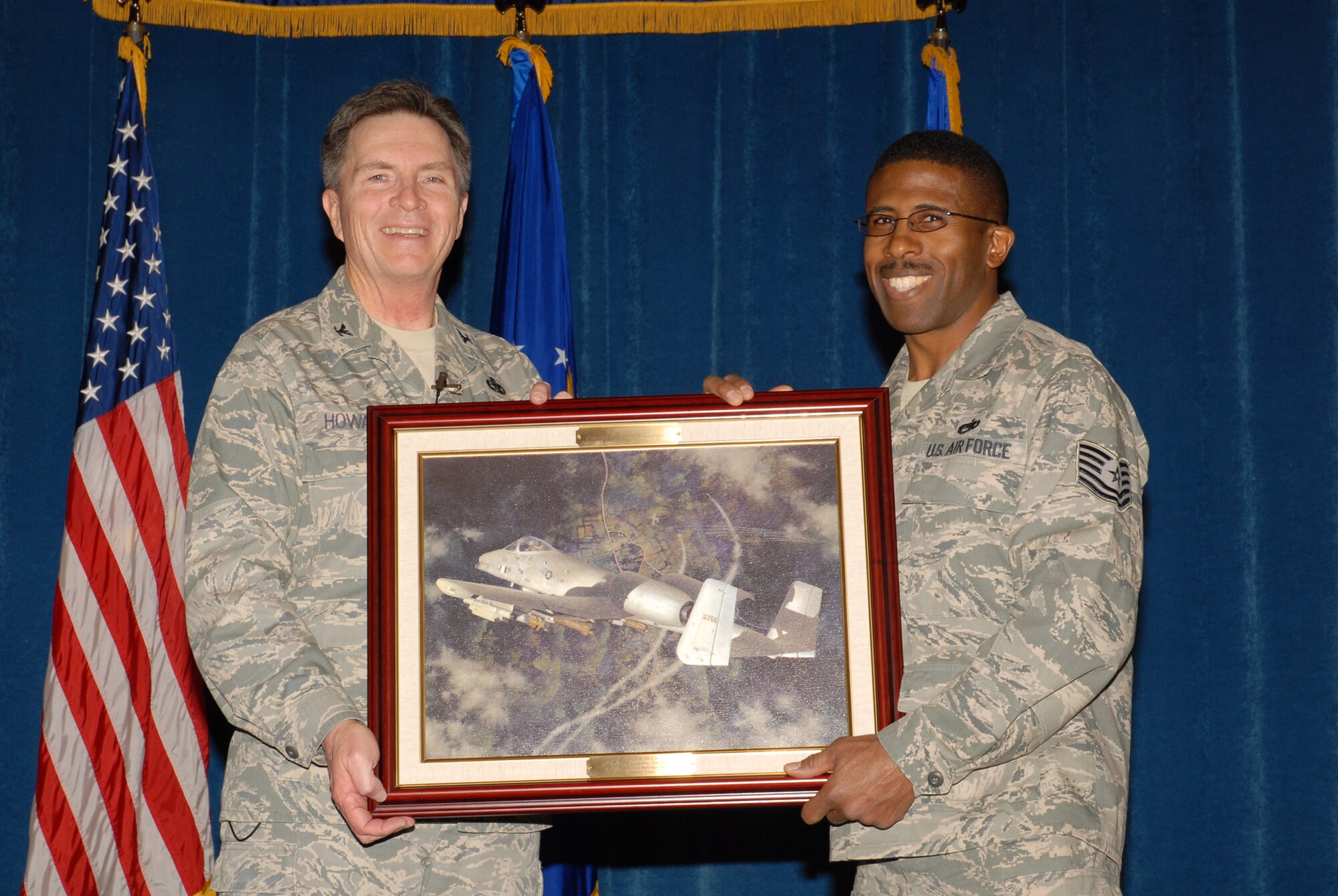 McGHEE TYSON AIR NATIONAL GUARD BASE, Tenn. -- Tech. Sgt. Tyrone E. Melton, right, an enlisted professional military education instructor, receives a heritage painting from Col. Richard B. Howard, commander, upon his departure from assignment at The I.G. Brown Air National Guard Training and Education Center here, Dec. 18, 2009.  (U.S. Air Force photograph by Master Sgt. Mavi Smith/Released)