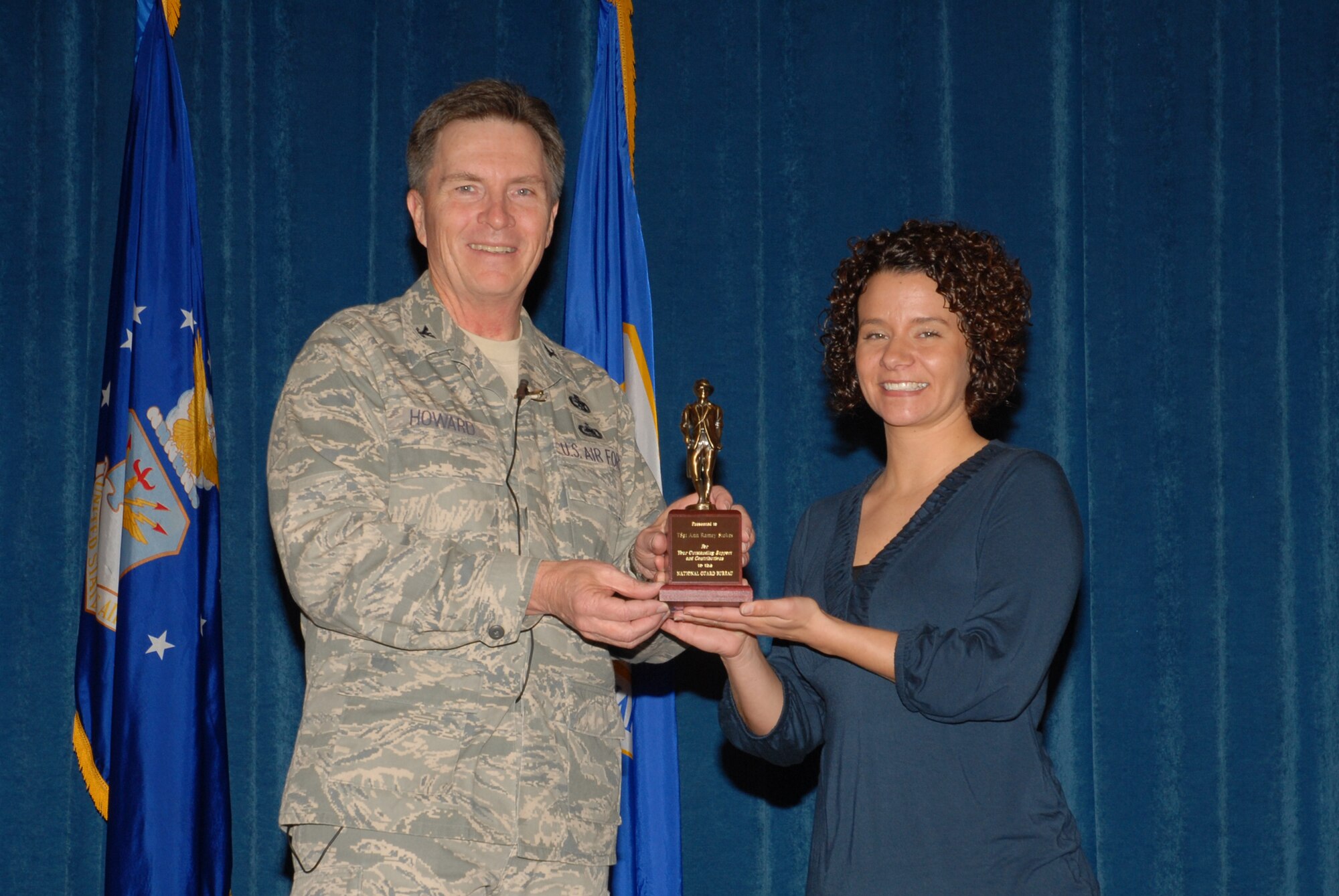 McGHEE TYSON AIR NATIONAL GUARD BASE, Tenn. -- Tech. Sgt. A. Ramey Stokes, right, an enlisted professional military education instructor, receives the National Guard Bureau minuteman award from Col. Richard B. Howard, commander, upon her departure from assignment at The I.G. Brown Air National Guard Training and Education Center here, Dec. 18, 2009.  (U.S. Air Force photograph by Master Sgt. Mavi Smith/Released)