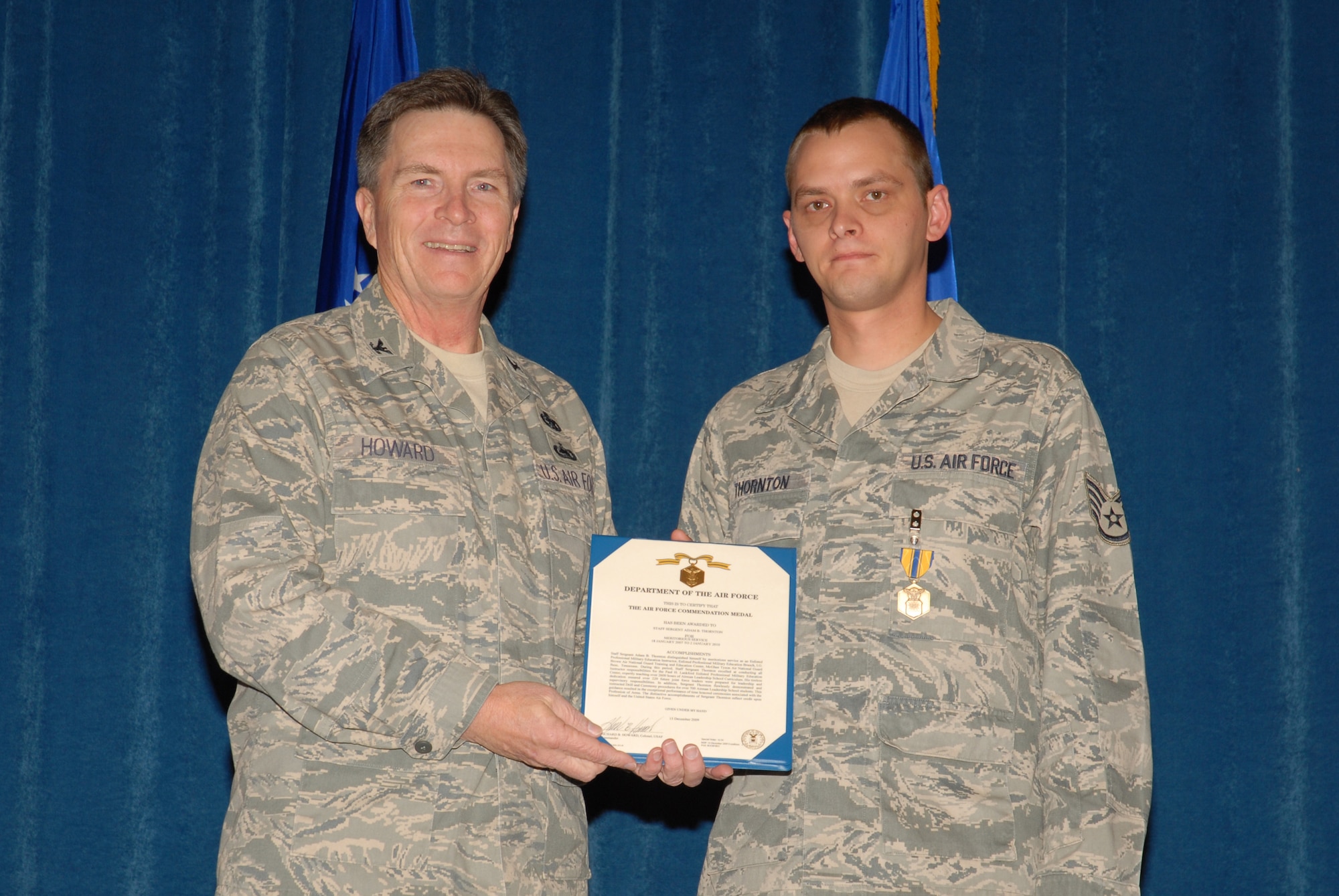 McGHEE TYSON AIR NATIONAL GUARD BASE, Tenn. -- Col. Richard B. Howard, left, commander, presents the Air Force Commendation medal to Staff Sgt. Adam B. Thornton, an enlisted professional military education instructor, upon his departure from assignment at The I.G. Brown Air National Guard Training and Education Center here, Dec. 18, 2009. (U.S. Air Force photograph by Master Sgt. Mavi Smith/Released)
